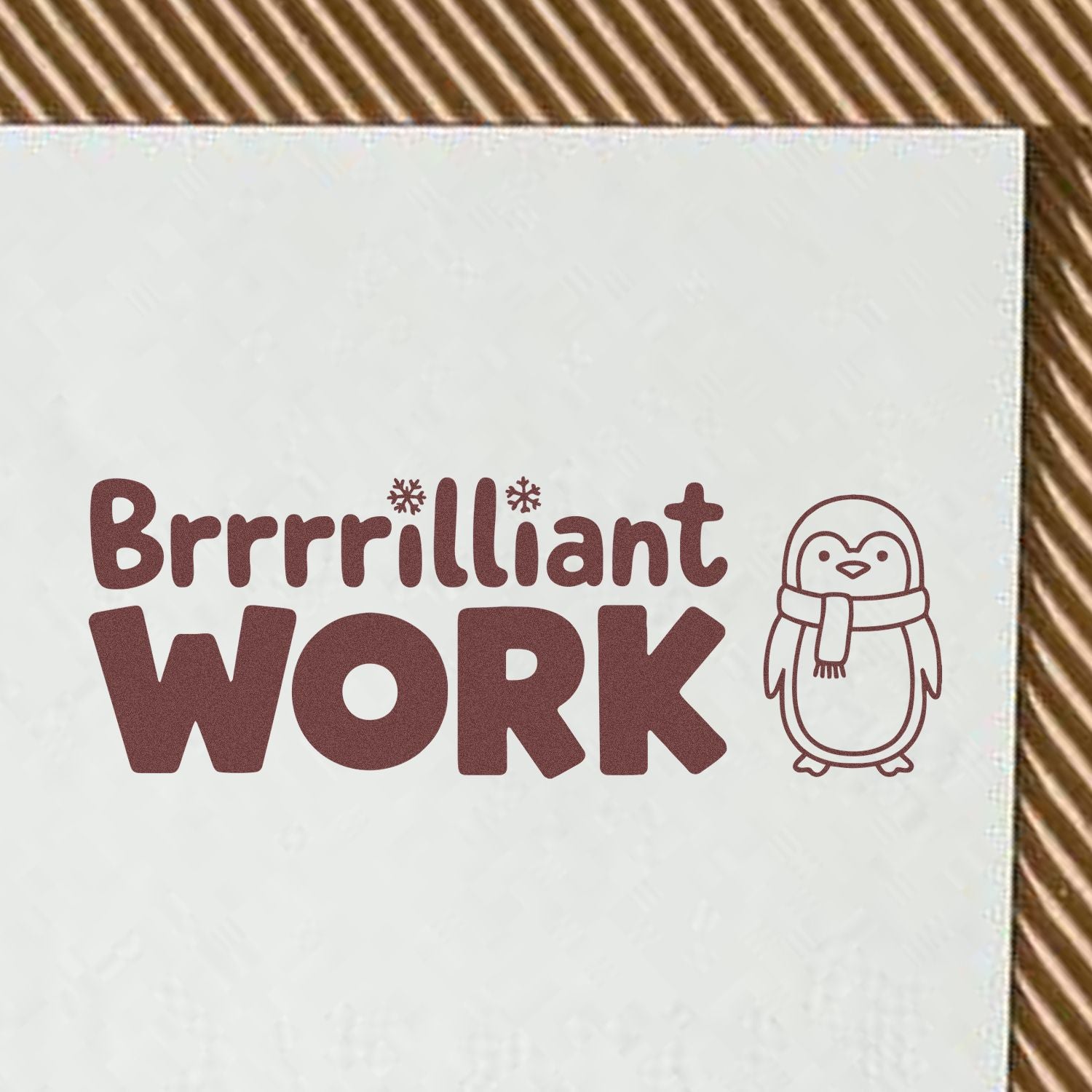 Maroon stamp and seal design reading Brrrilliant WORK with a scarfed penguin on a white background.