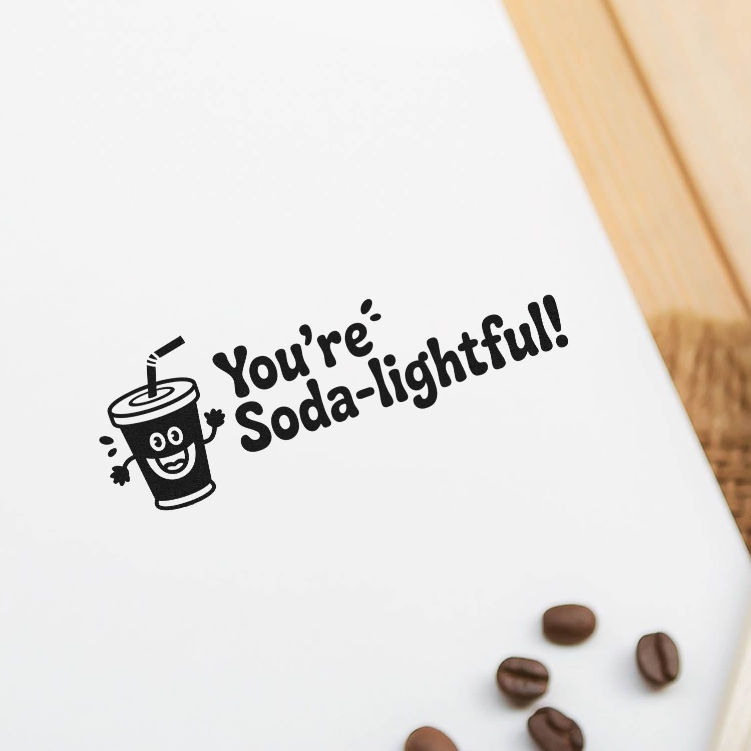 Black custom stamp seal with smiling soda cup and Youre Soda-lightful! in bold black on white paper.