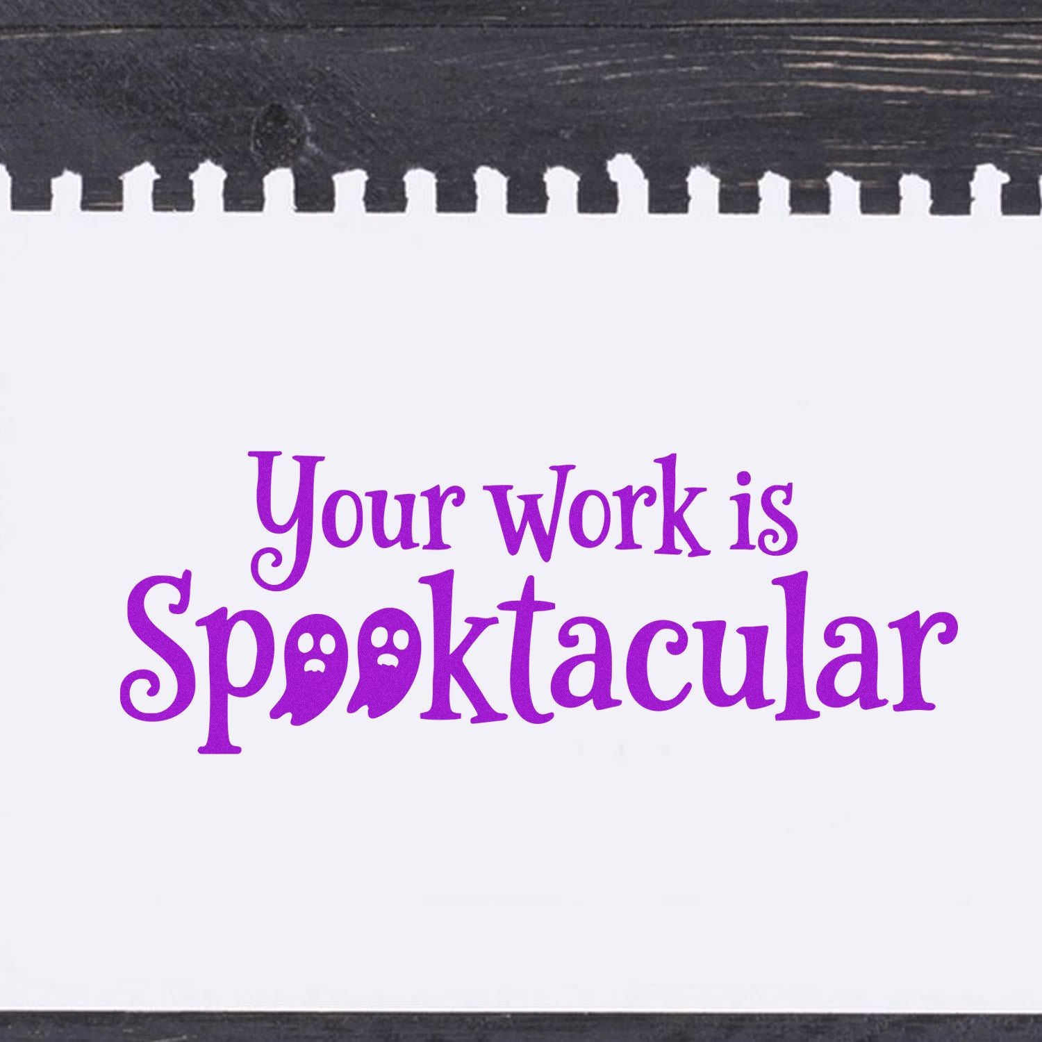 Purple rubber stamp reading Your work is Spooktacular with ghost letters on a white background and black borders.
