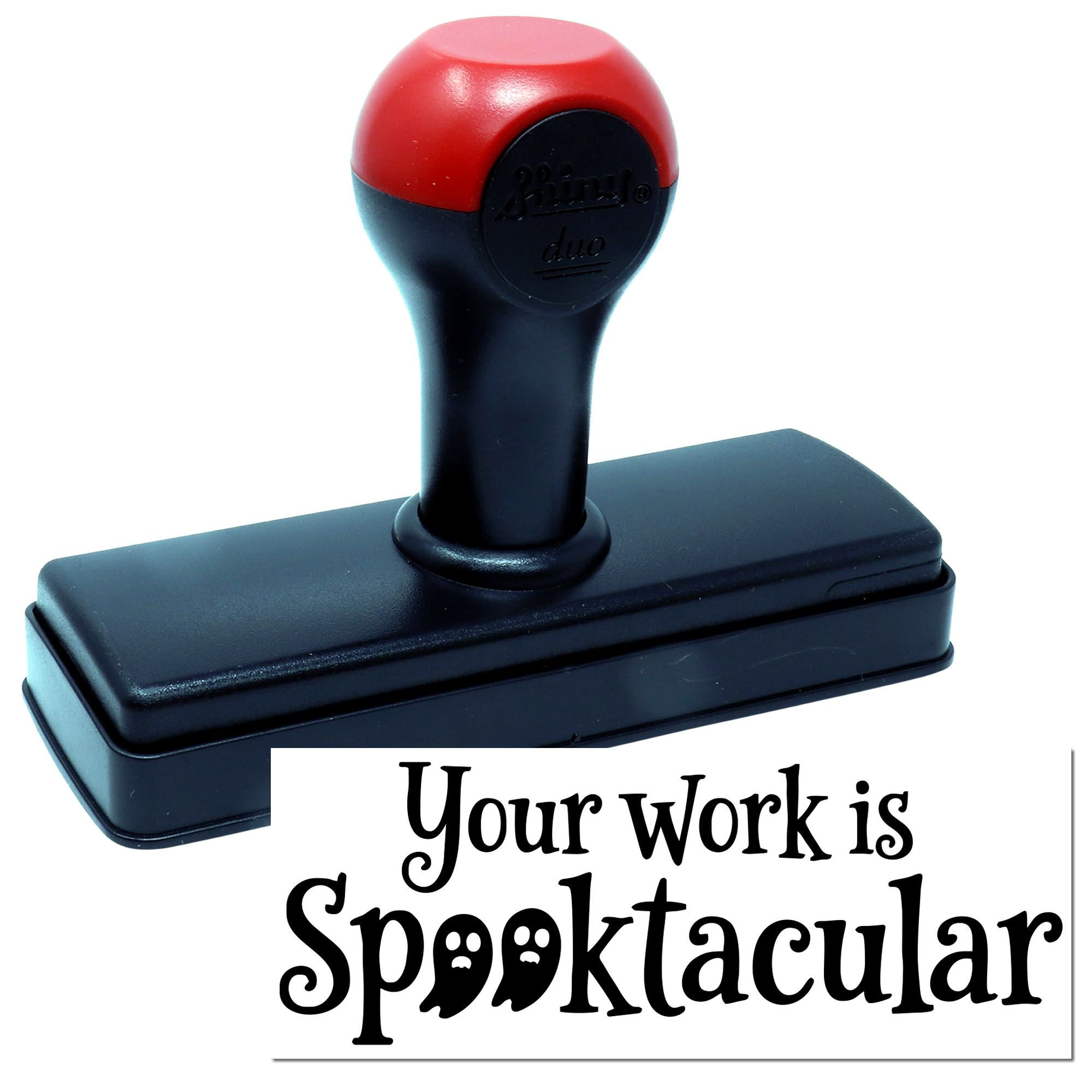 Black rubber stamp with red top and spooky Your work is Spooktacular seal impression on white background.