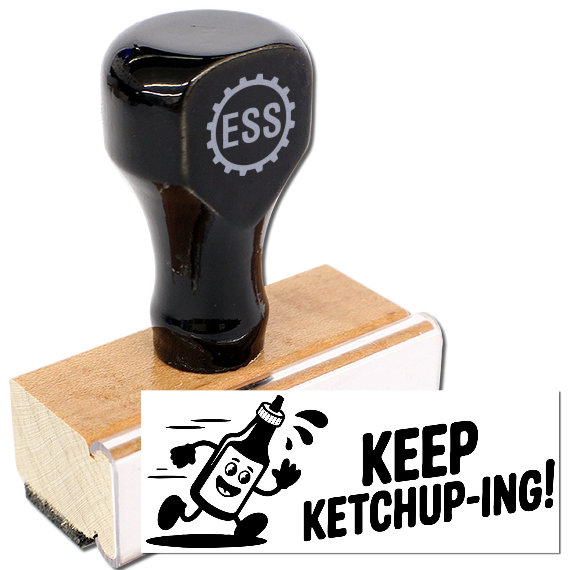 Black self-inking stamp on wooden block with ESS gear logo, showing a playful KEEP KETCHUP-ING ketchup design.