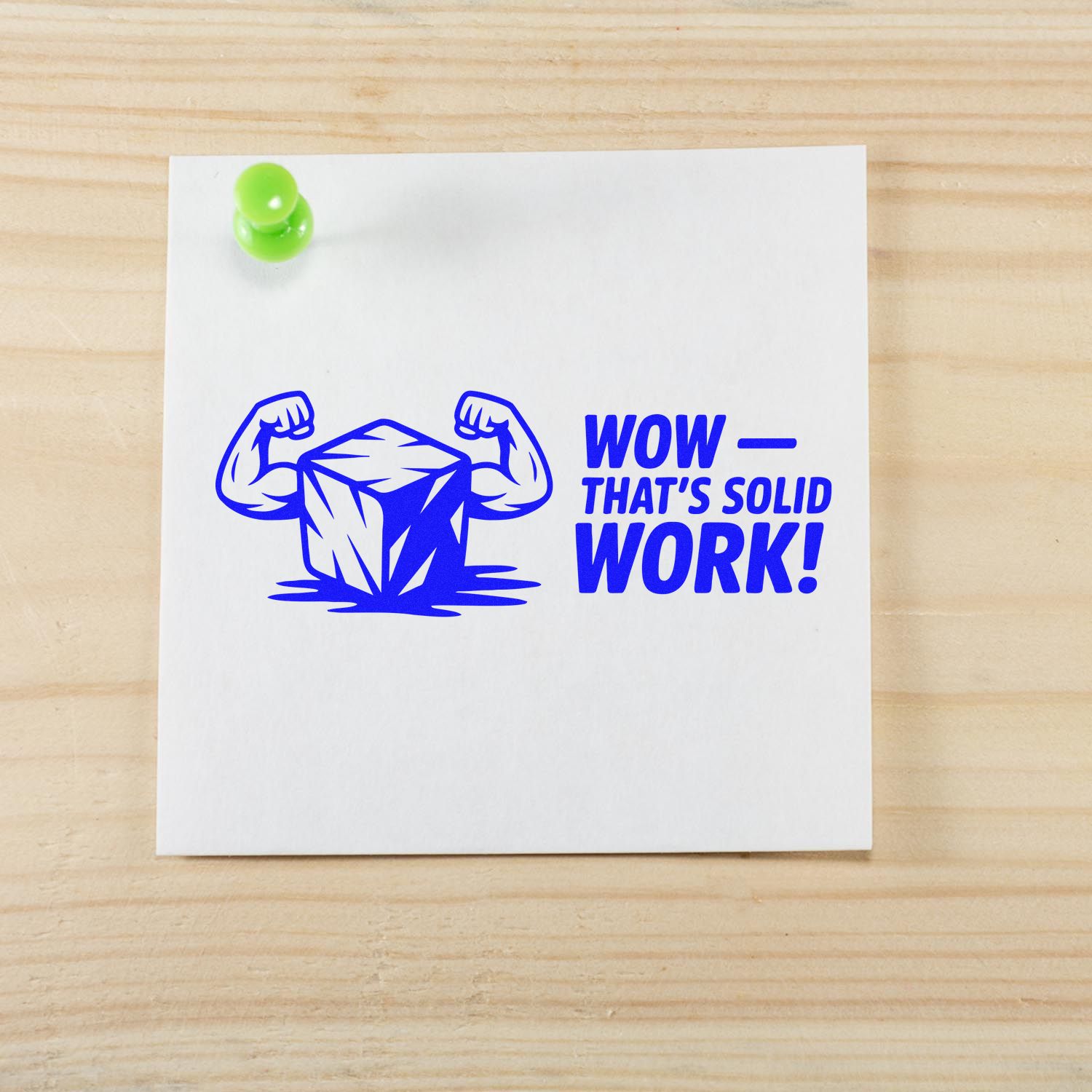 Blue rubber stamp seal with flexing cube and WOW THATS SOLID WORK! on white paper, pinned with a green tack.