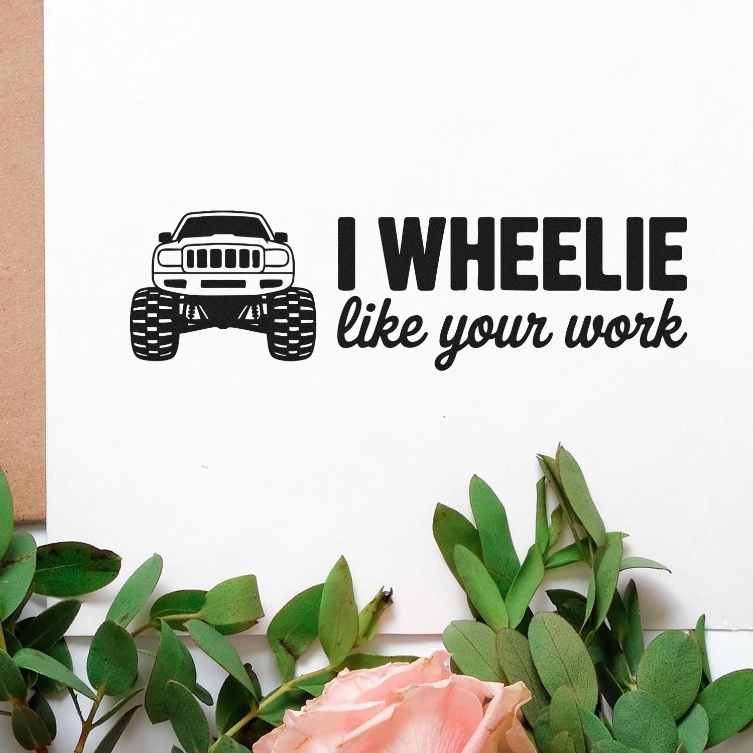 Black custom stamp with off-road truck graphic and I WHEELIE like your work on white paper, with green leaves and pink rose.