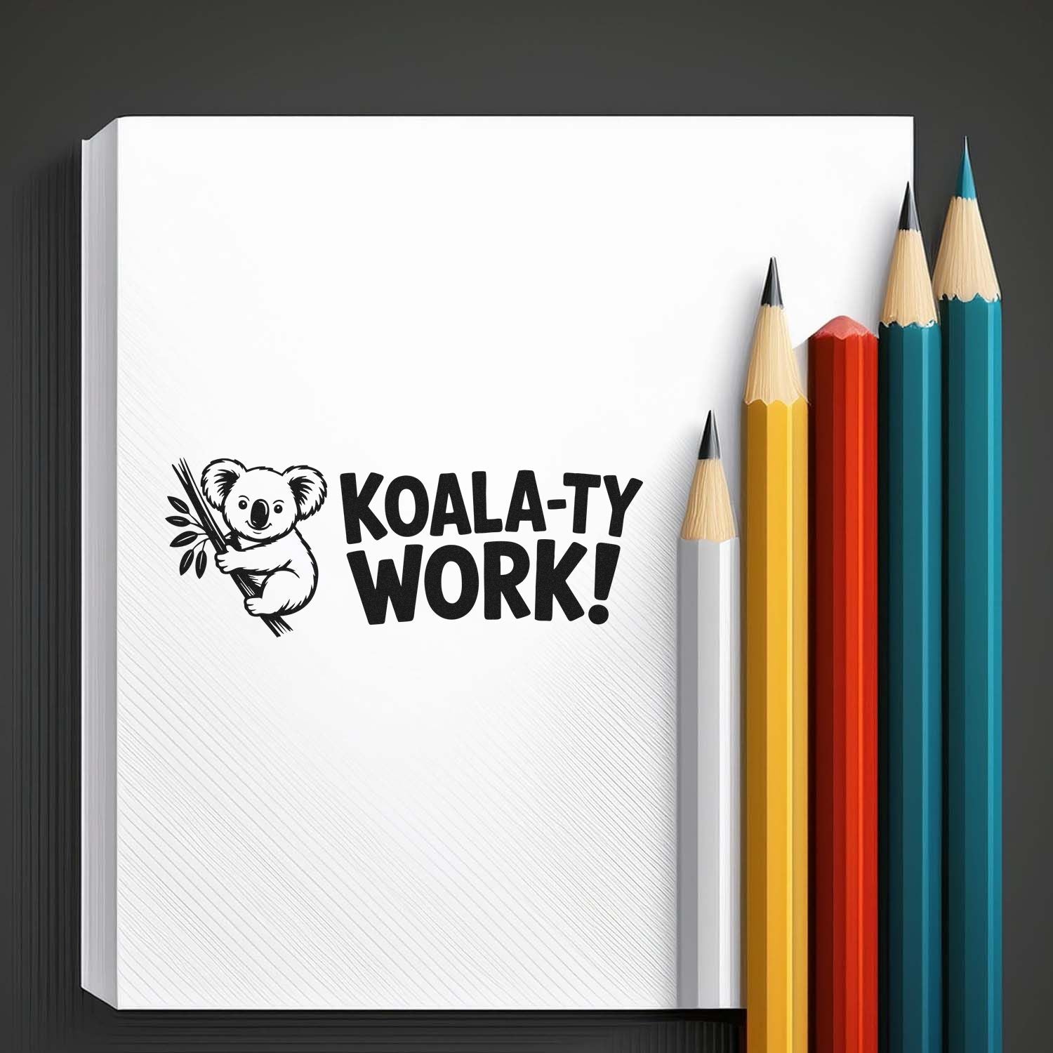 Koala-ty Work! black stamp seal on white paper, with koala graphic and yellow, red, teal, and white pencils.