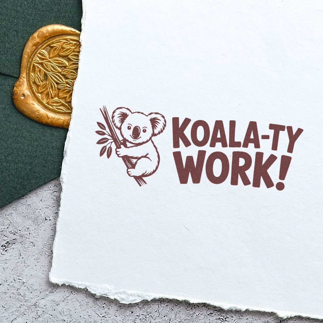 Brown koala stamp with KOALA-TY WORK! on white paper, beside a gold embossed seal on dark green background.