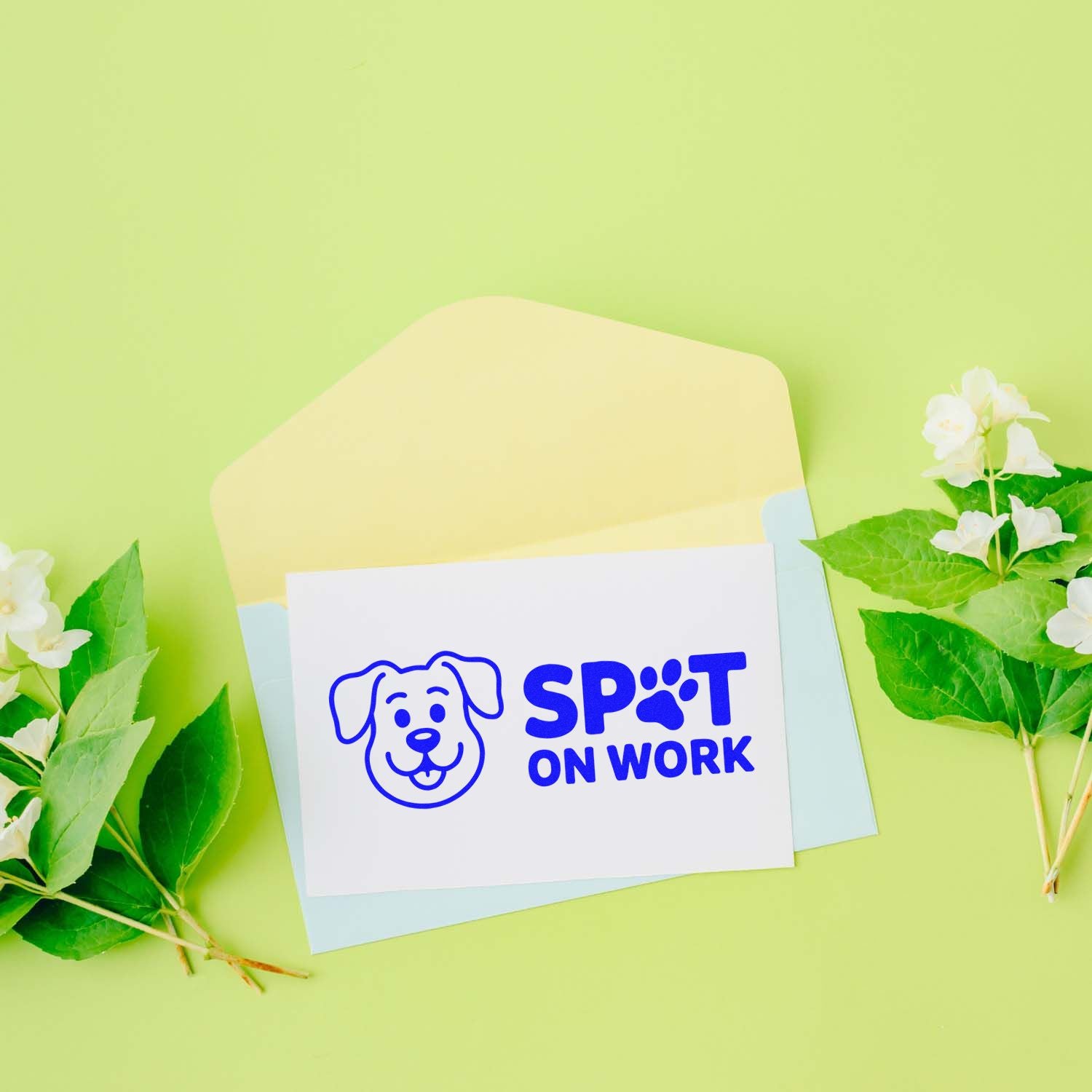 Blue dog Spot On Work stamp seal on white card with pastel envelopes and green leaves on light green background