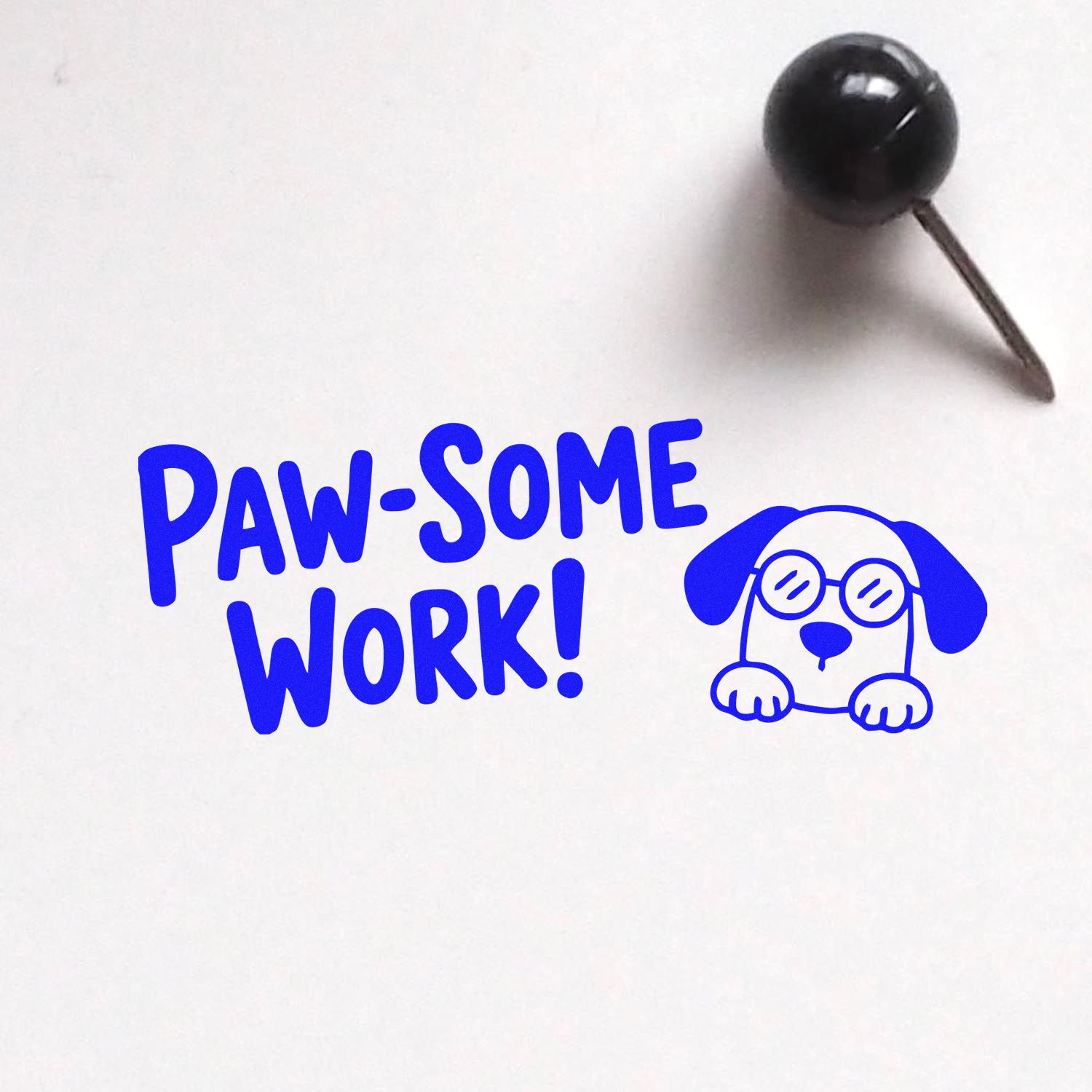 Black rubber stamp seal with blue Paw-some Work! text and dog icon on a white background.