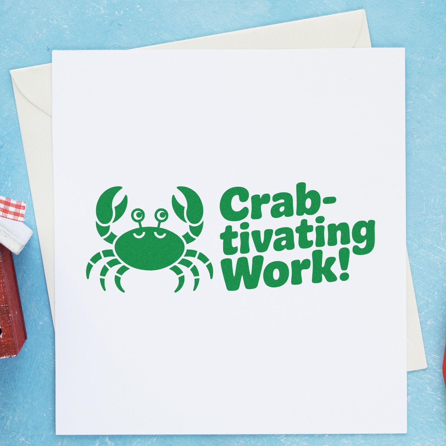 Green crab stamp and seal with Crab-tivating Work! on a white card, shown on a light blue background with envelopes.