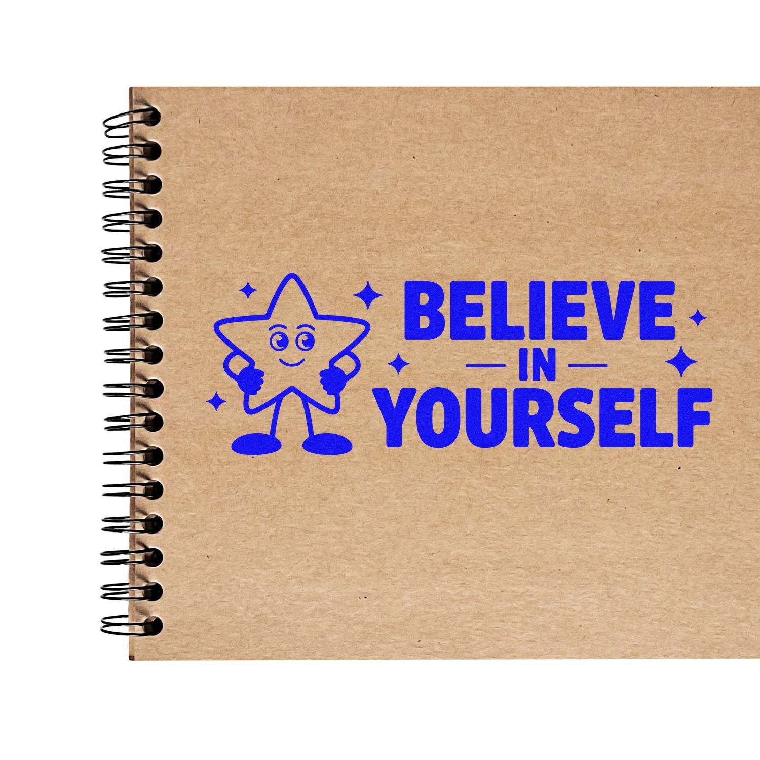 Blue rubber stamp seal with smiling star and Believe in Yourself on a kraft spiral notebook cover.