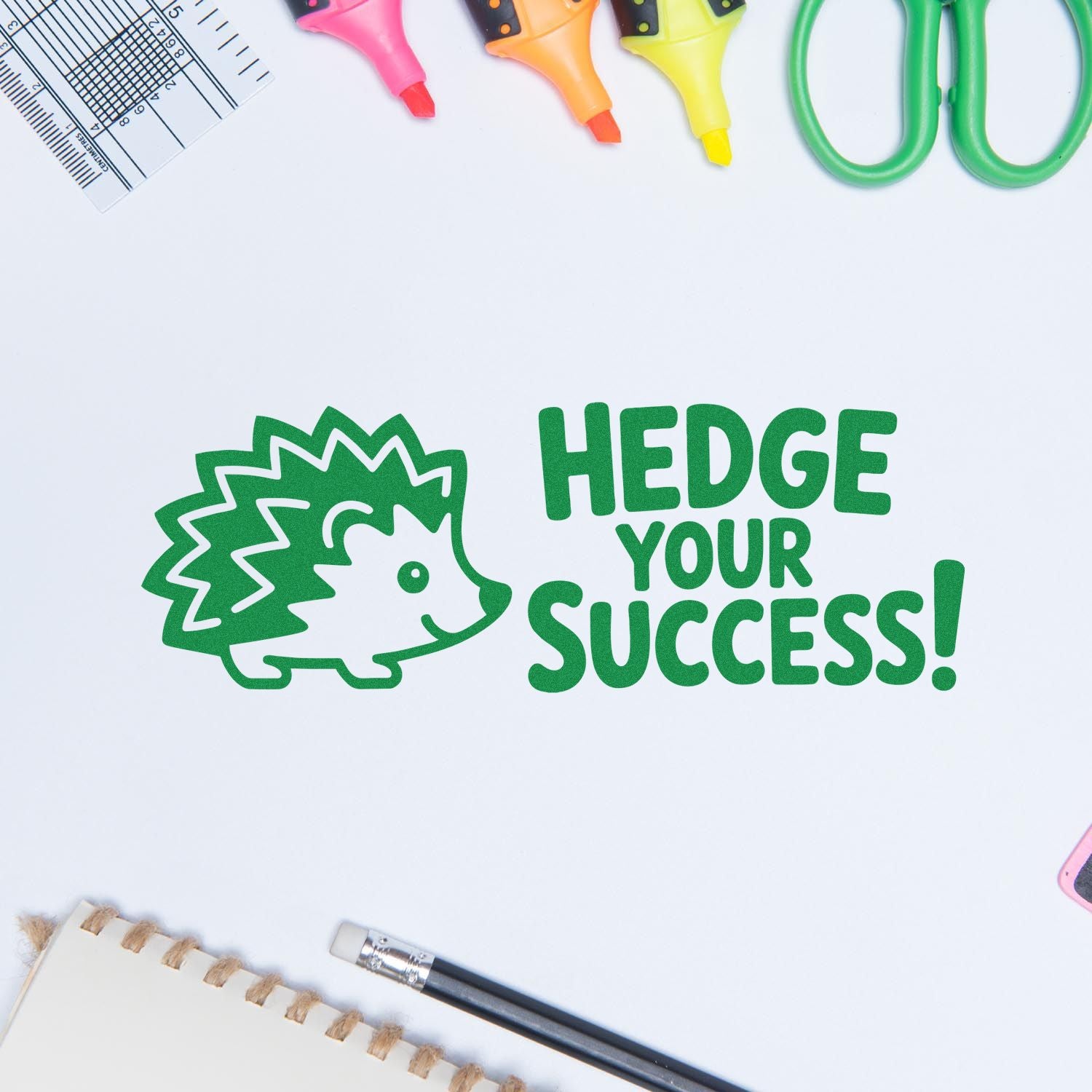 Green hedgehog stamp and seal with Hedge Your Success! beside colorful markers, scissors, and ruler.