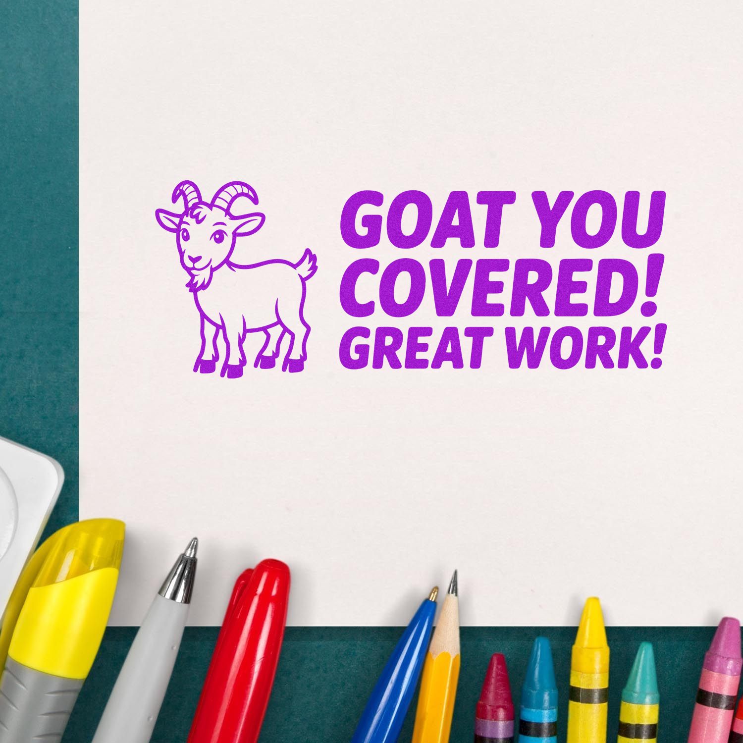 Purple goat stamp seal reading GOAT YOU COVERED! GREAT WORK! with colorful pens on white paper