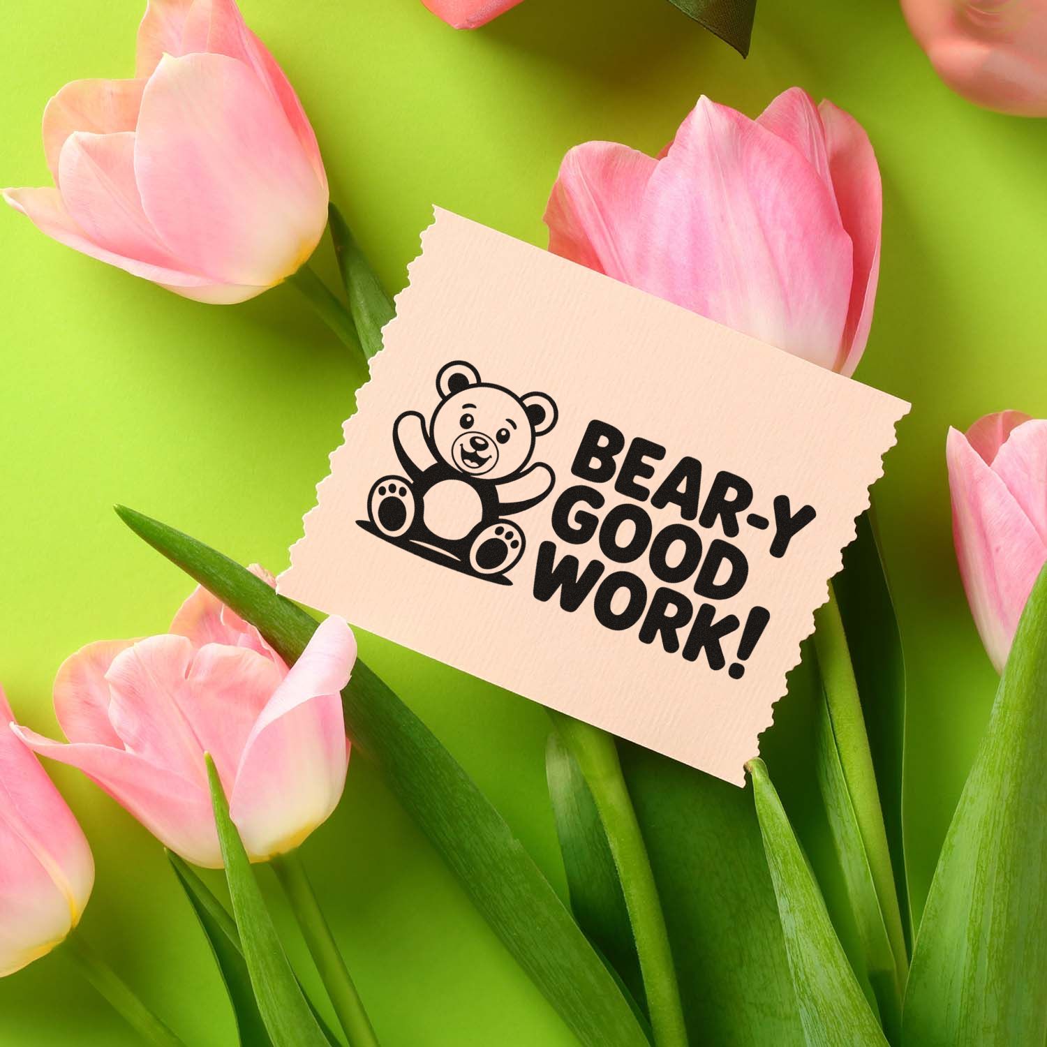 Beige bear-themed stamp and seal card reading BEAR-Y GOOD WORK! surrounded by pink tulips on bright green.