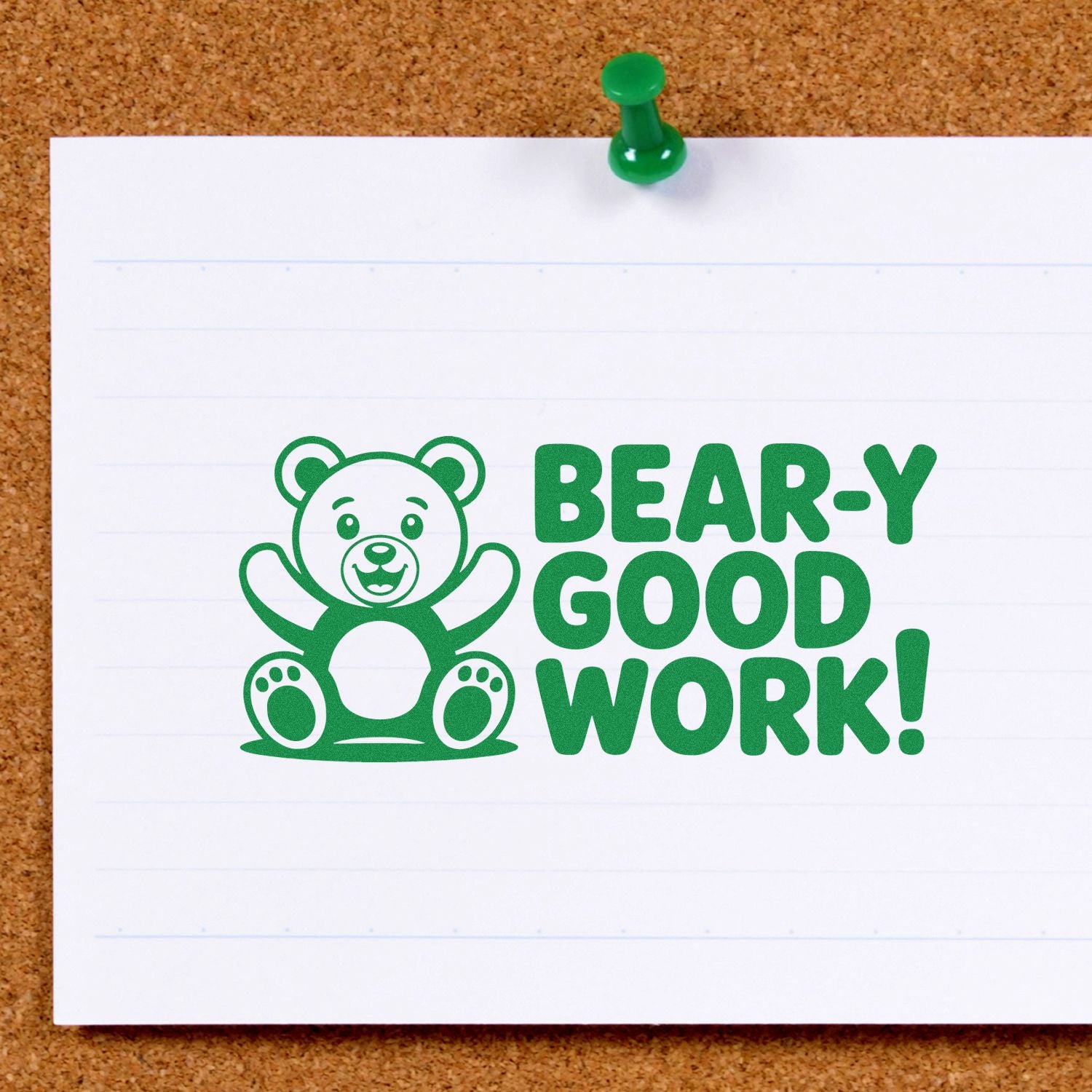 Green bear reward stamp on white paper reading BEAR-Y GOOD WORK! with green pushpin on corkboard.