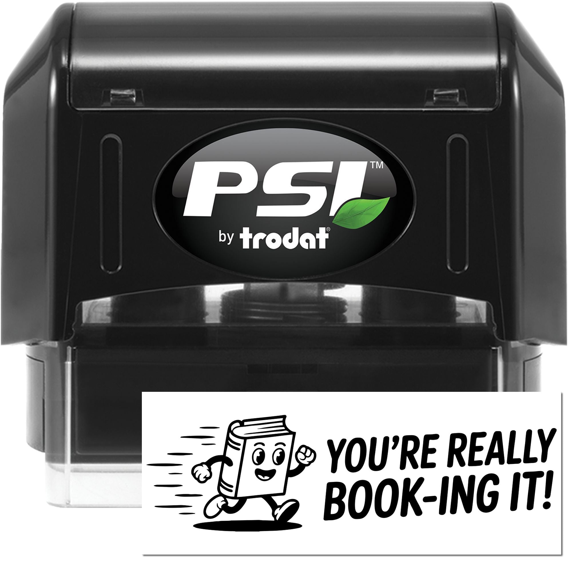 Black PSI by Trodat self-inking stamp and seal, black casing with green leaf logo, beside a white Youre really book-ing it! card.