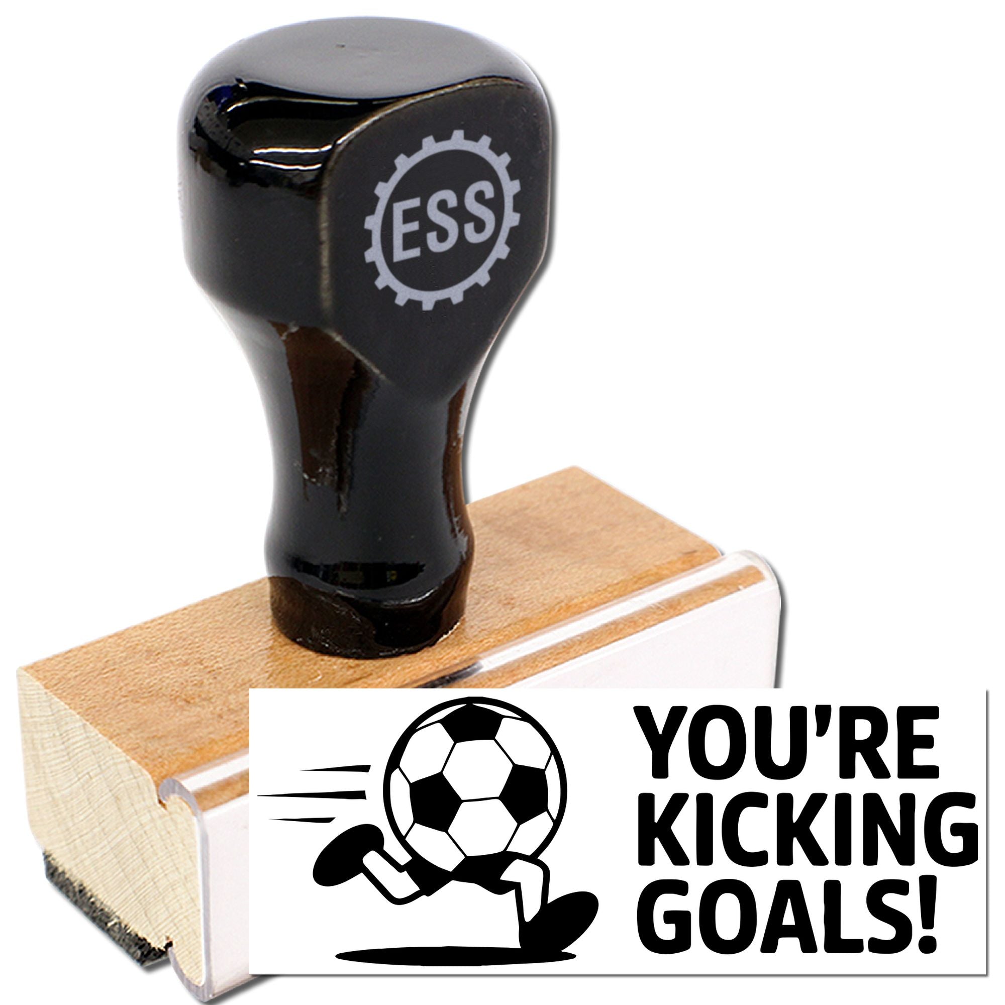 Black rubber stamp seal with soccer ball runner and YOURE KICKING GOALS! on a wooden block.