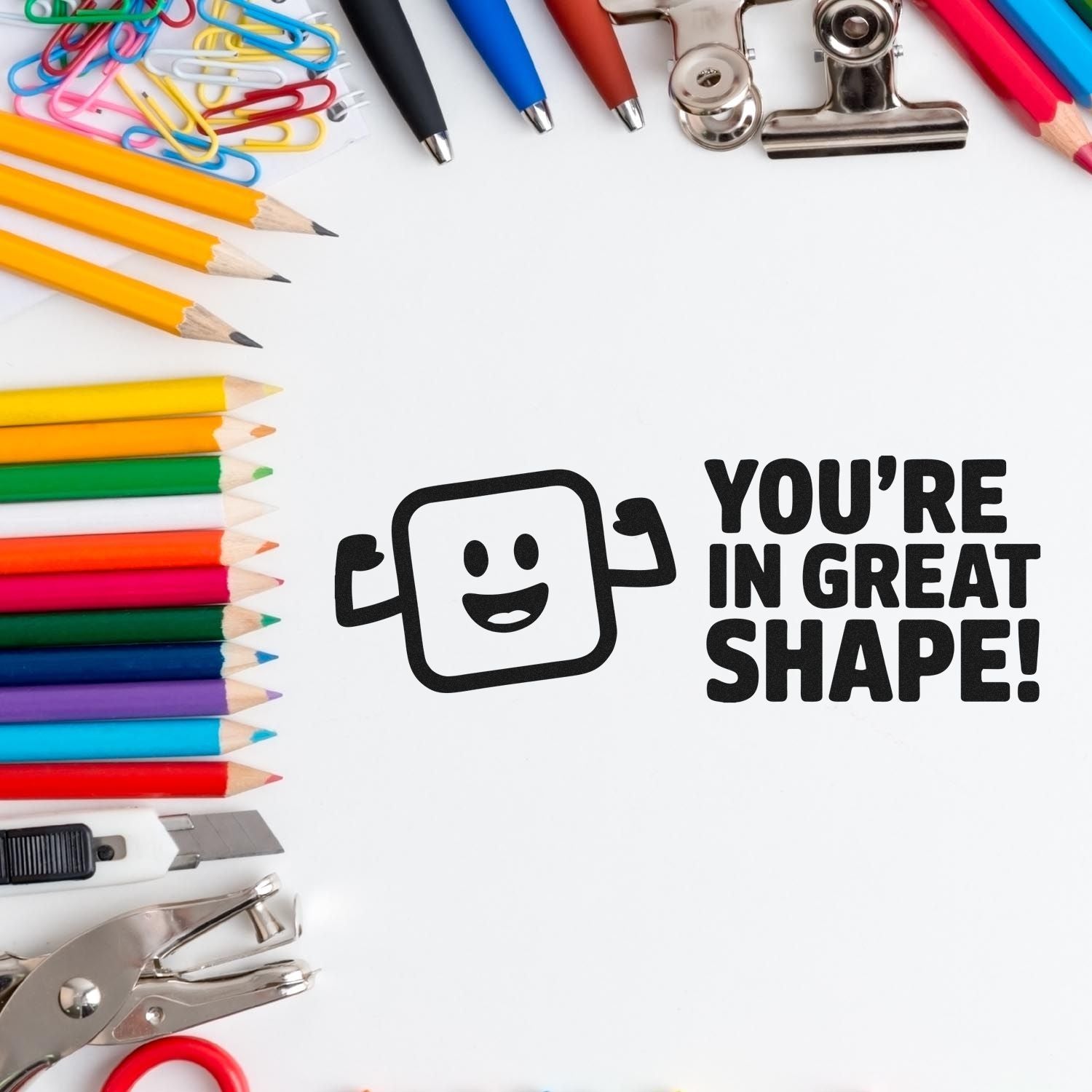 Colorful pencils, pens, clips and seal tools framing a smiley stamp that says Youre in great shape!