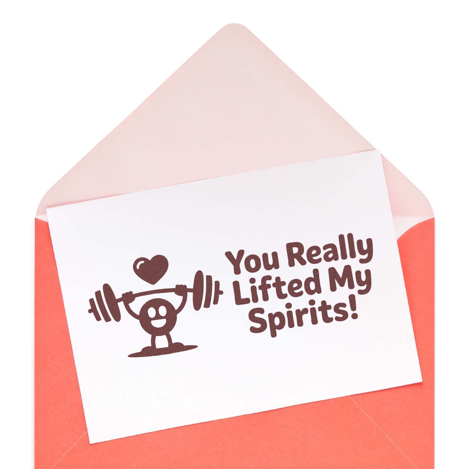 Brown custom stamp on white card in a coral envelope, with weightlifter heart graphic and text: You Really Lifted My Spirits!