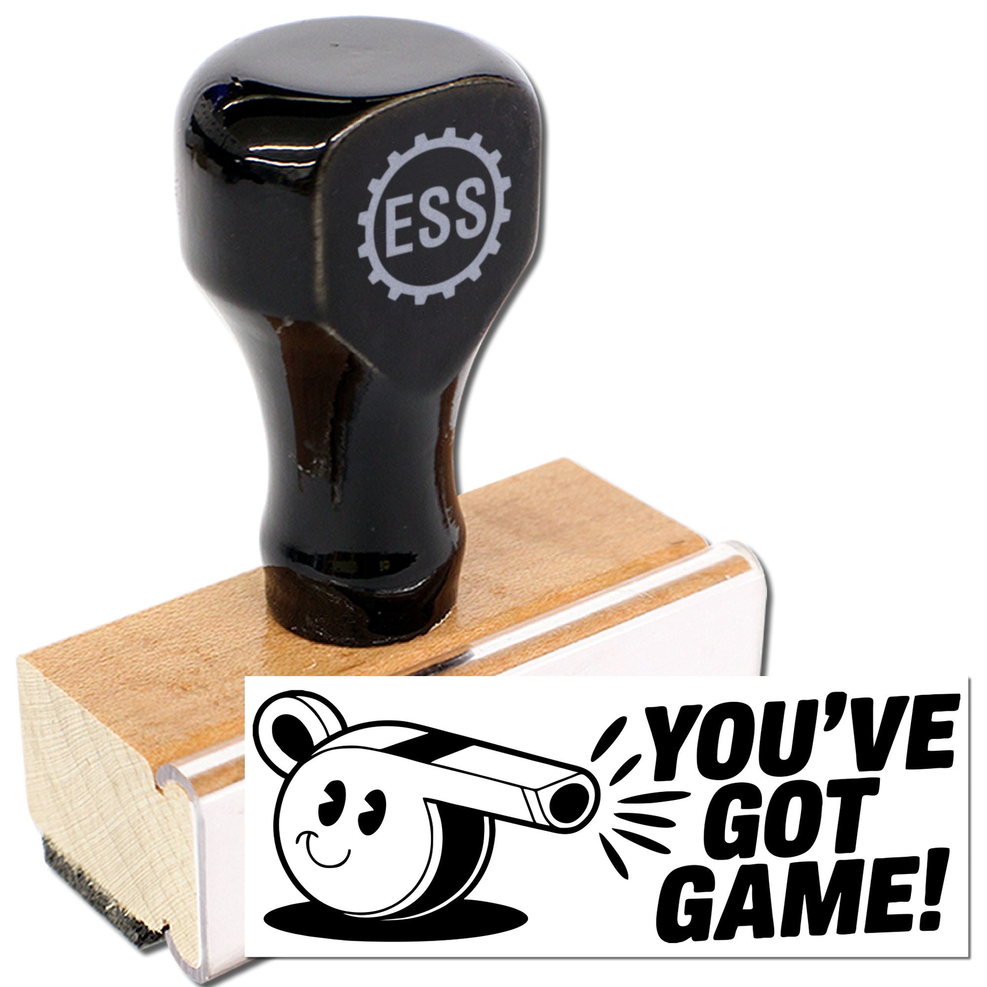 Black rubber stamp and seal on a wooden block, printing a white YOUVE GOT GAME! design with a cartoon whistle.