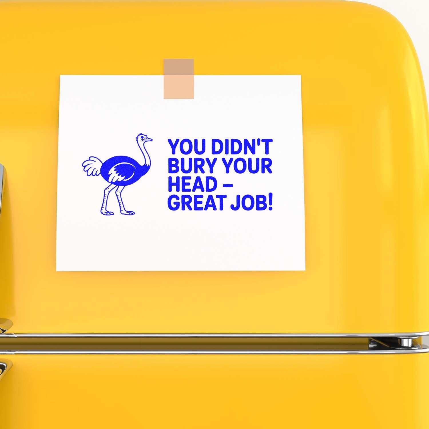 White card taped on a yellow background with a blue custom stamp and seal featuring an ostrich and You didnt bury your headgreat job!