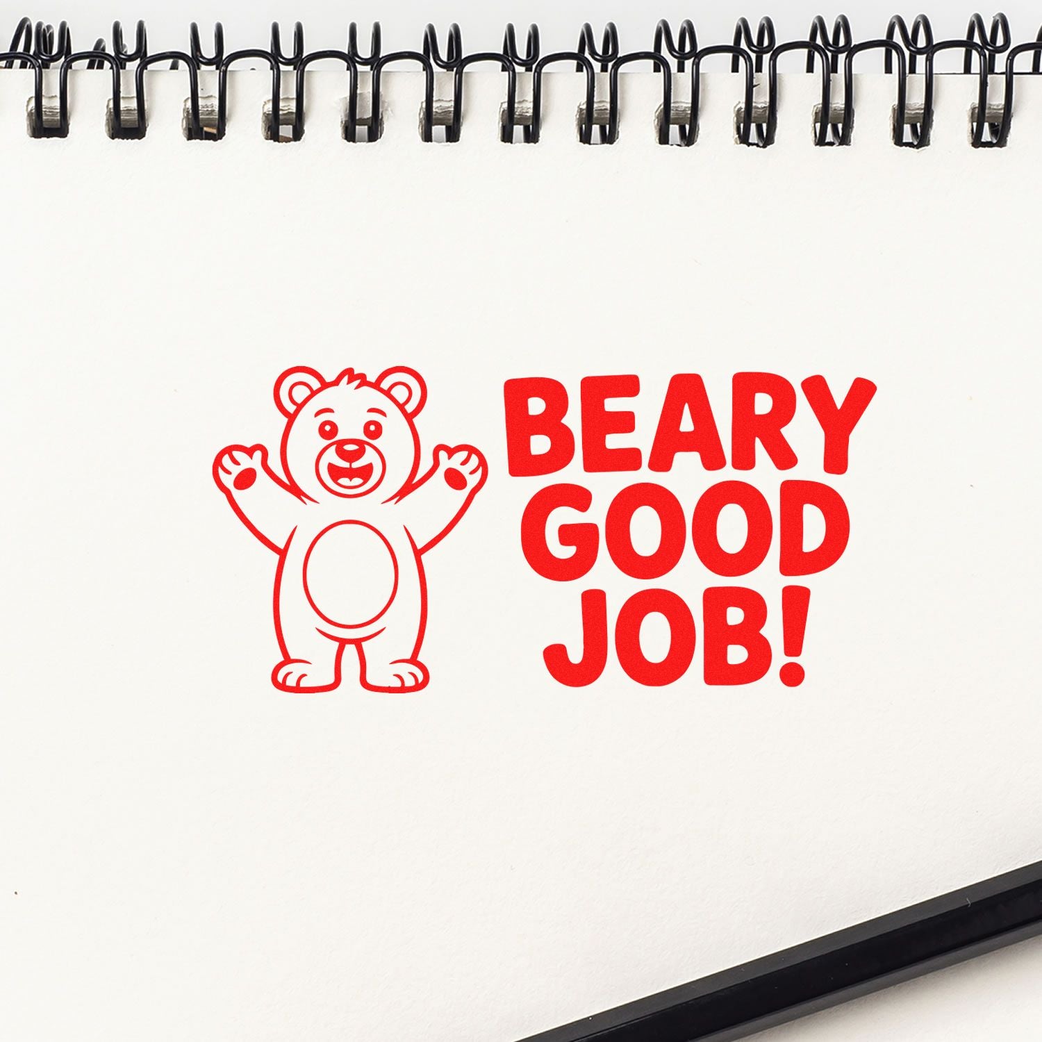 Red bear stamp seal with BEARY GOOD JOB! on a white spiral-bound page.