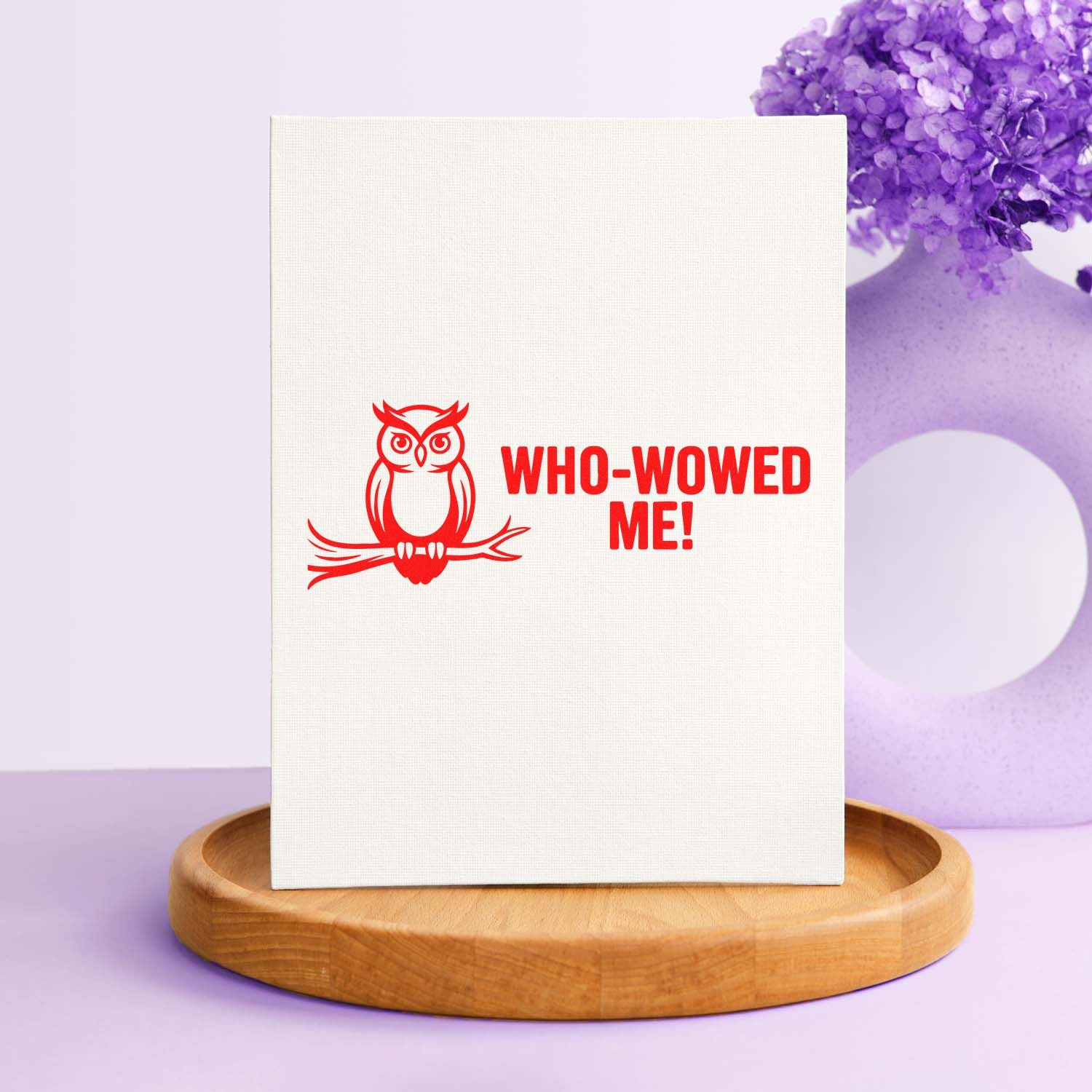 Red owl stamp and seal reading WHO-WOWED ME! on a white canvas, with a lavender backdrop and wood base.