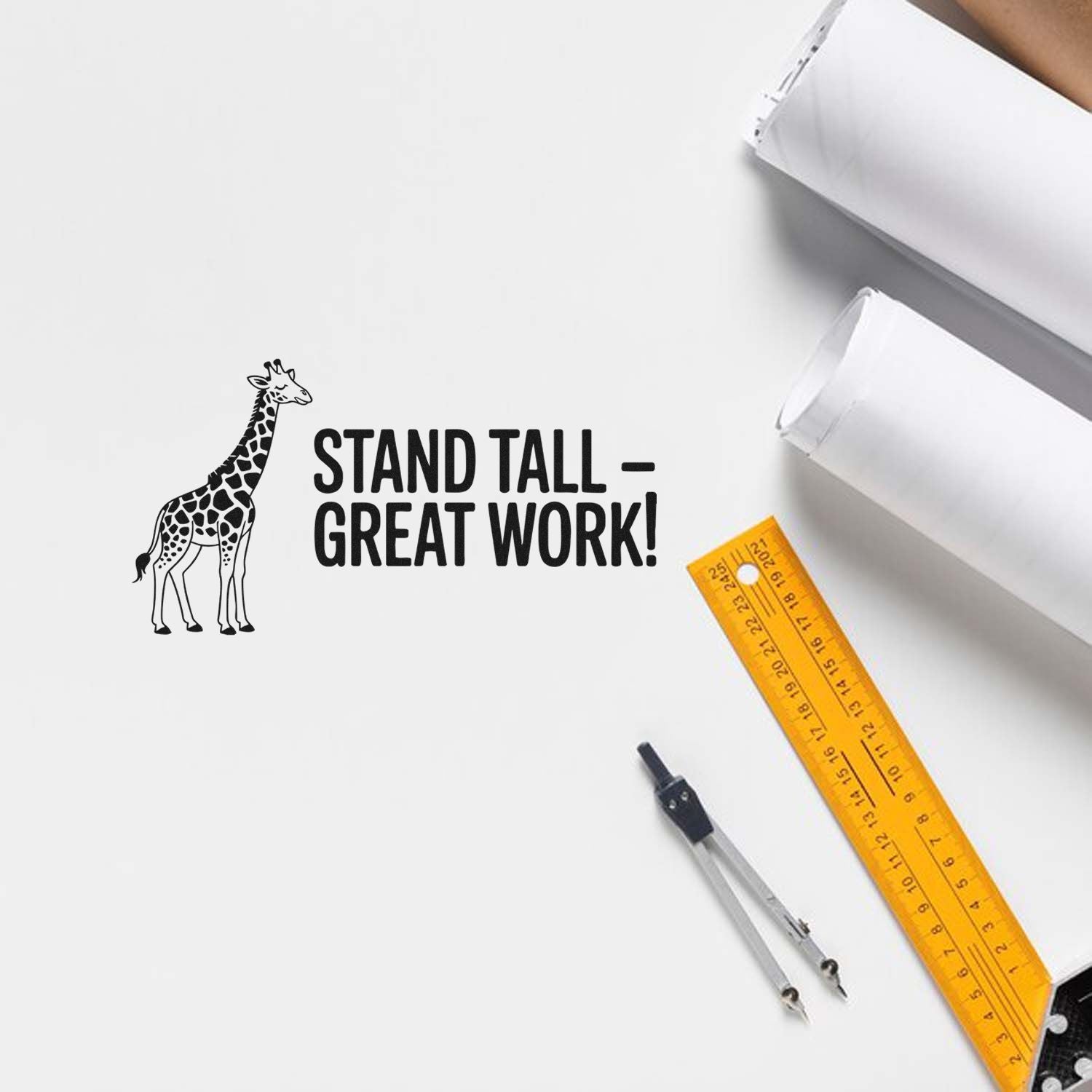Black giraffe stamp reading Stand Tall Great Work! on white paper with white stamp and seal products, yellow ruler, compass.