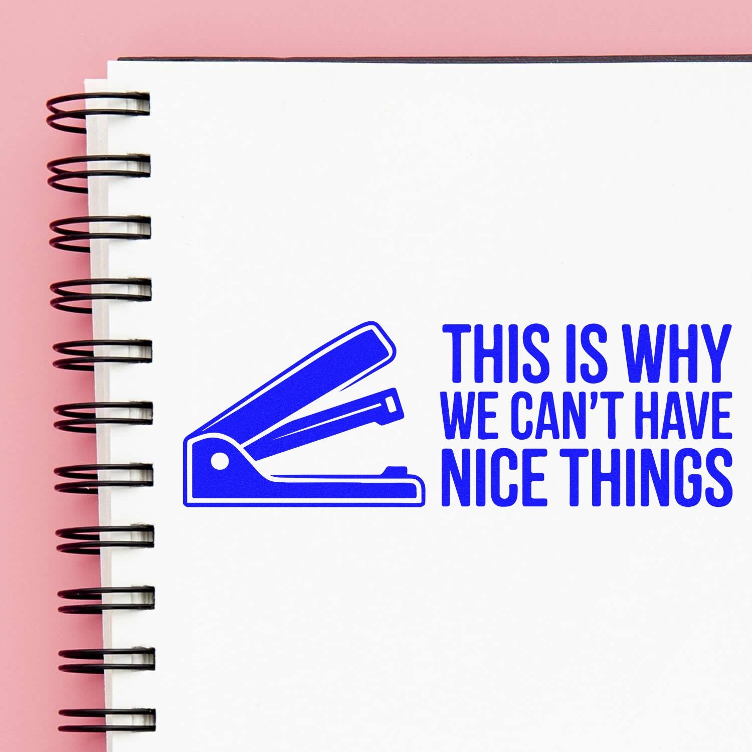 Blue stapler stamp and seal graphic with "This Is Why We Can't Have Nice Things" on a white spiral notebook, pink background.