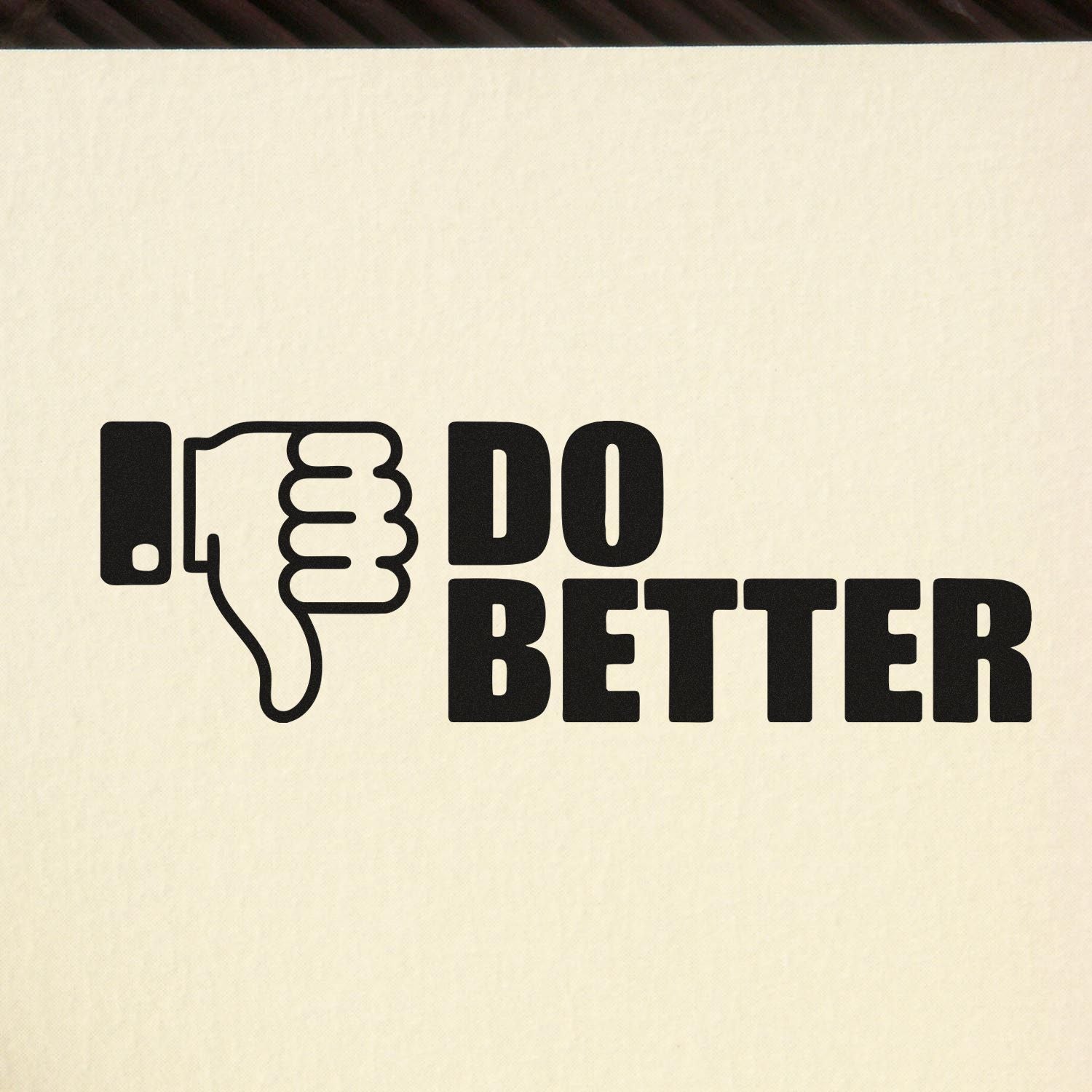 Black thumbs-down stamp seal with bold DO BETTER text on a cream background.