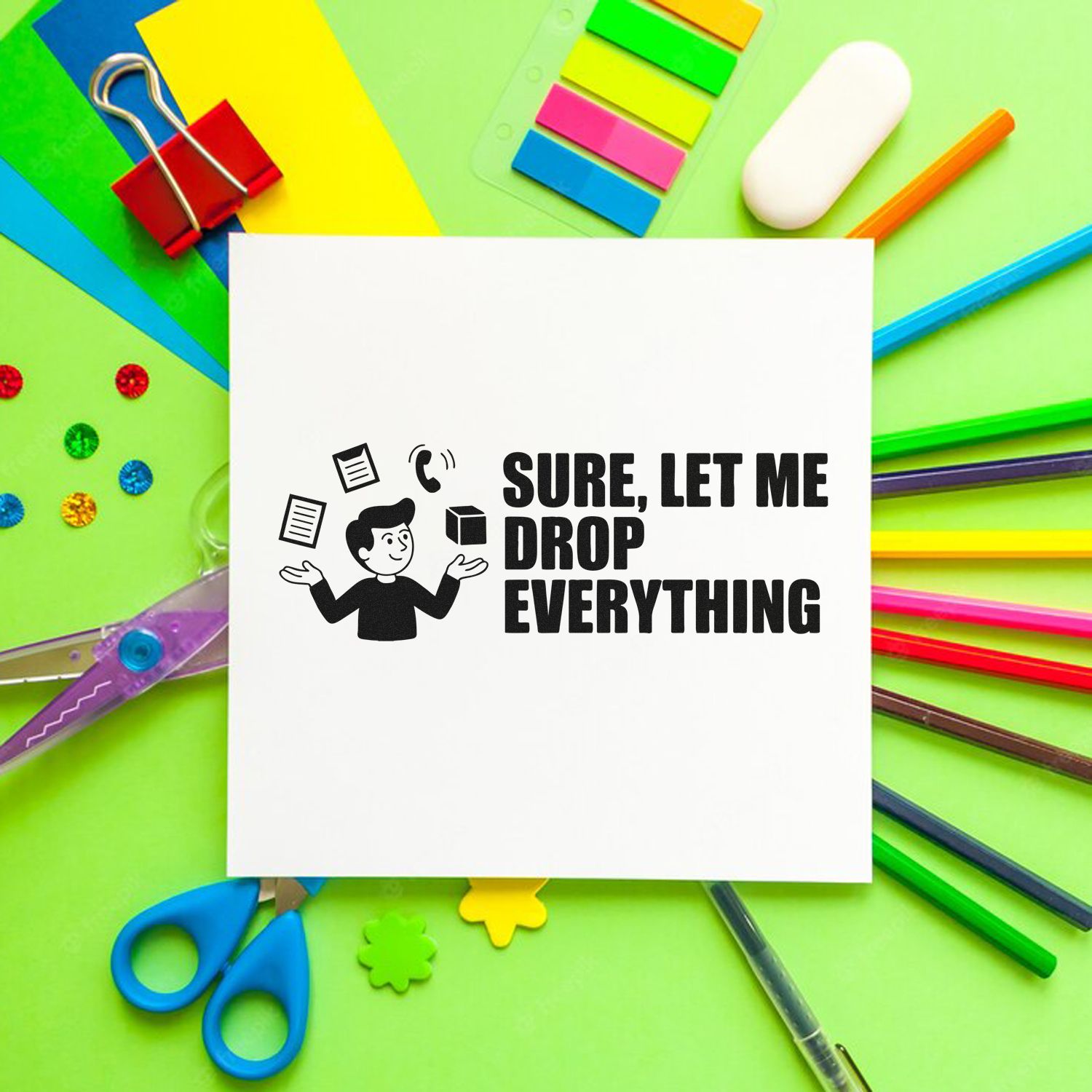 White custom stamp and seal sample with black Sure, let me drop everything design, surrounded by colorful stationery on green background.