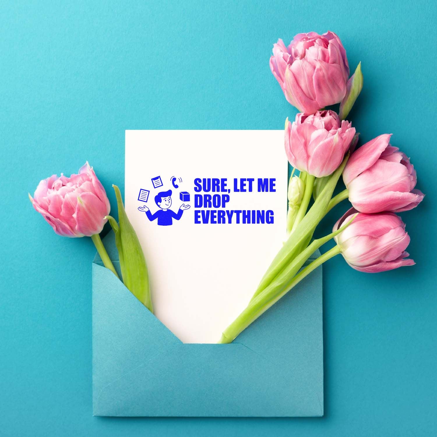 Blue stamp-seal card reading Sure, let me drop everything, in a teal envelope with pink tulips on a turquoise background.