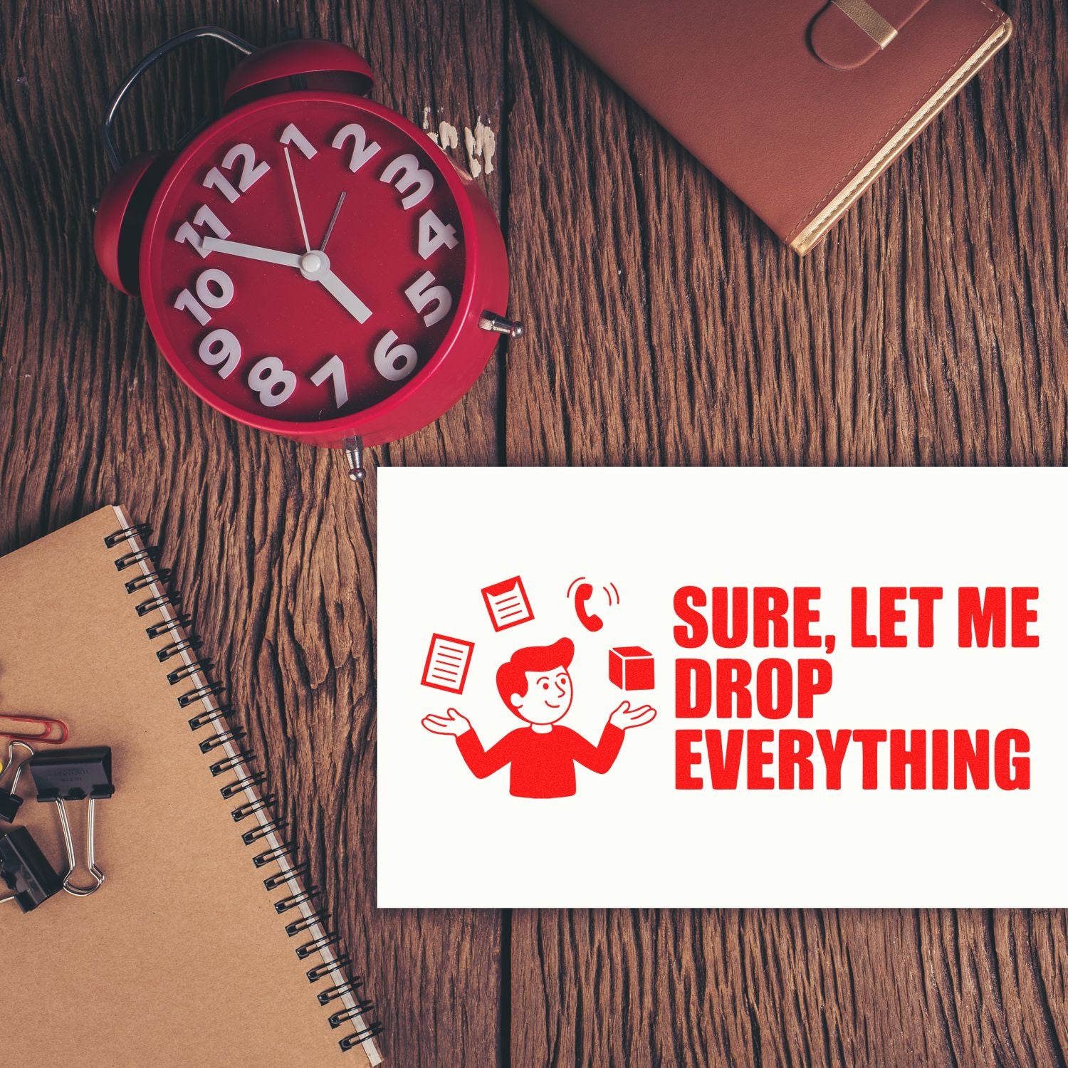 Red stamp and seal reading Sure, let me drop everything on white paper, on a wood desk with a red alarm clock.