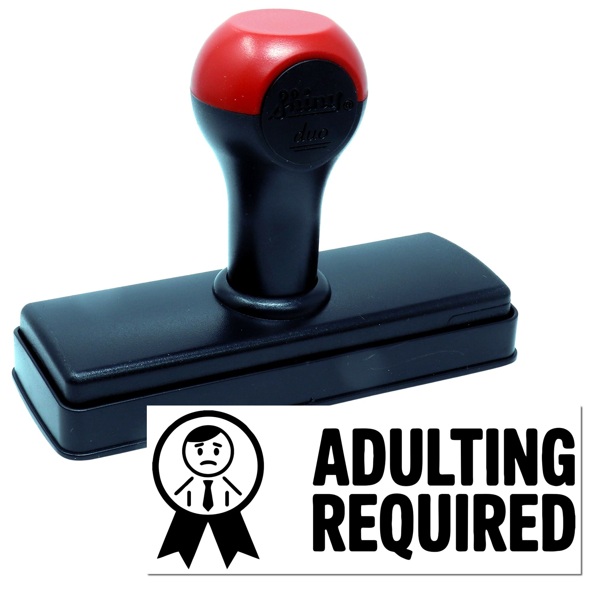 Red and black self-inking stamp seal with ADULTING REQUIRED marking and ribbon icon on white background.