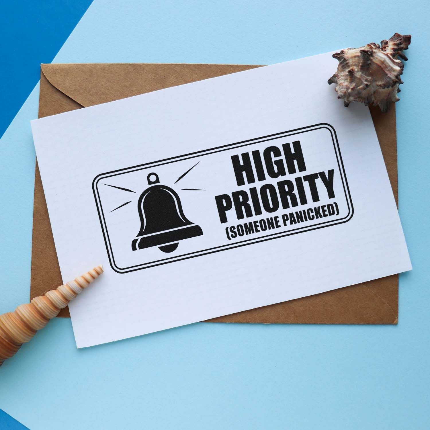 Custom stamp and seal design on white card: black high-priority bell graphic on brown envelope with seashell accents.