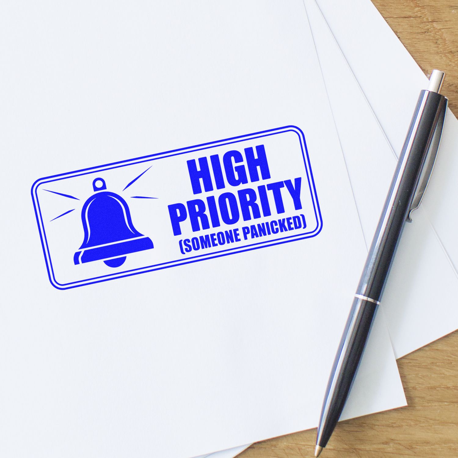 Blue high-priority stamp seal with bell icon on white paper beside a black-silver pen.