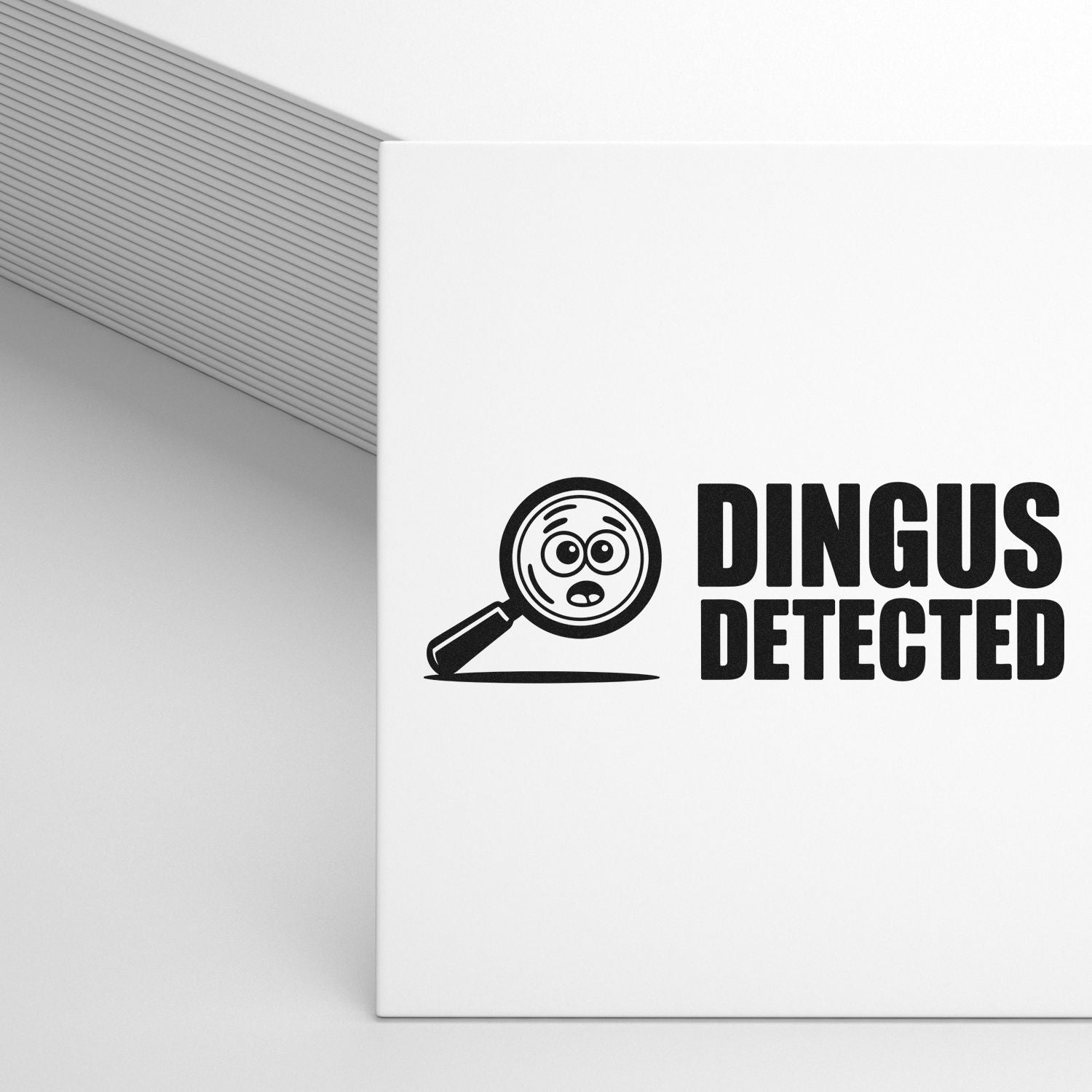 White stamp and seal product with black magnifying-glass face logo and bold DINGUS DETECTED text.