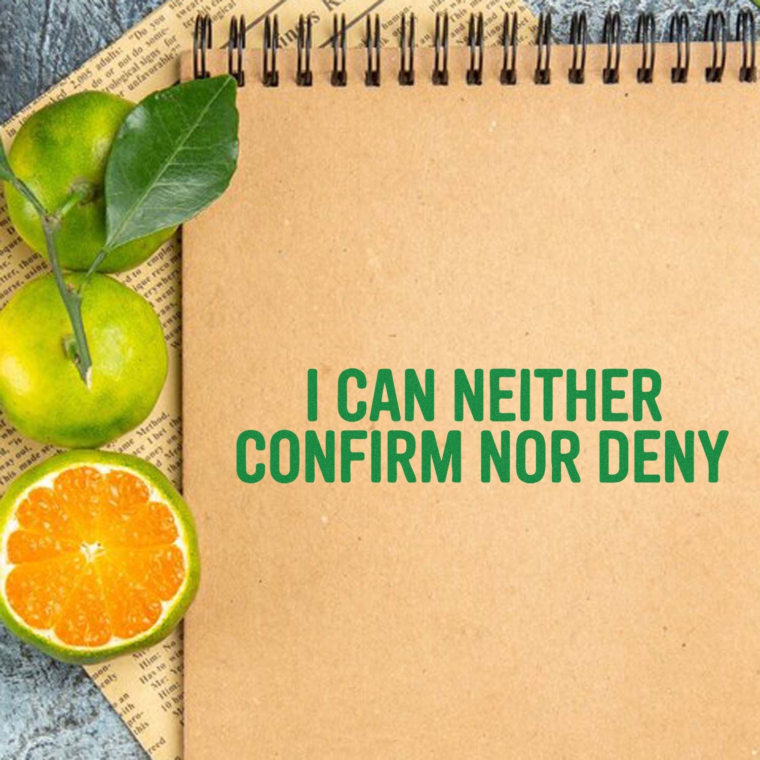 Kraft spiral notebook stamp and seal design with green I CAN NEITHER CONFIRM NOR DENY text and citrus accents.