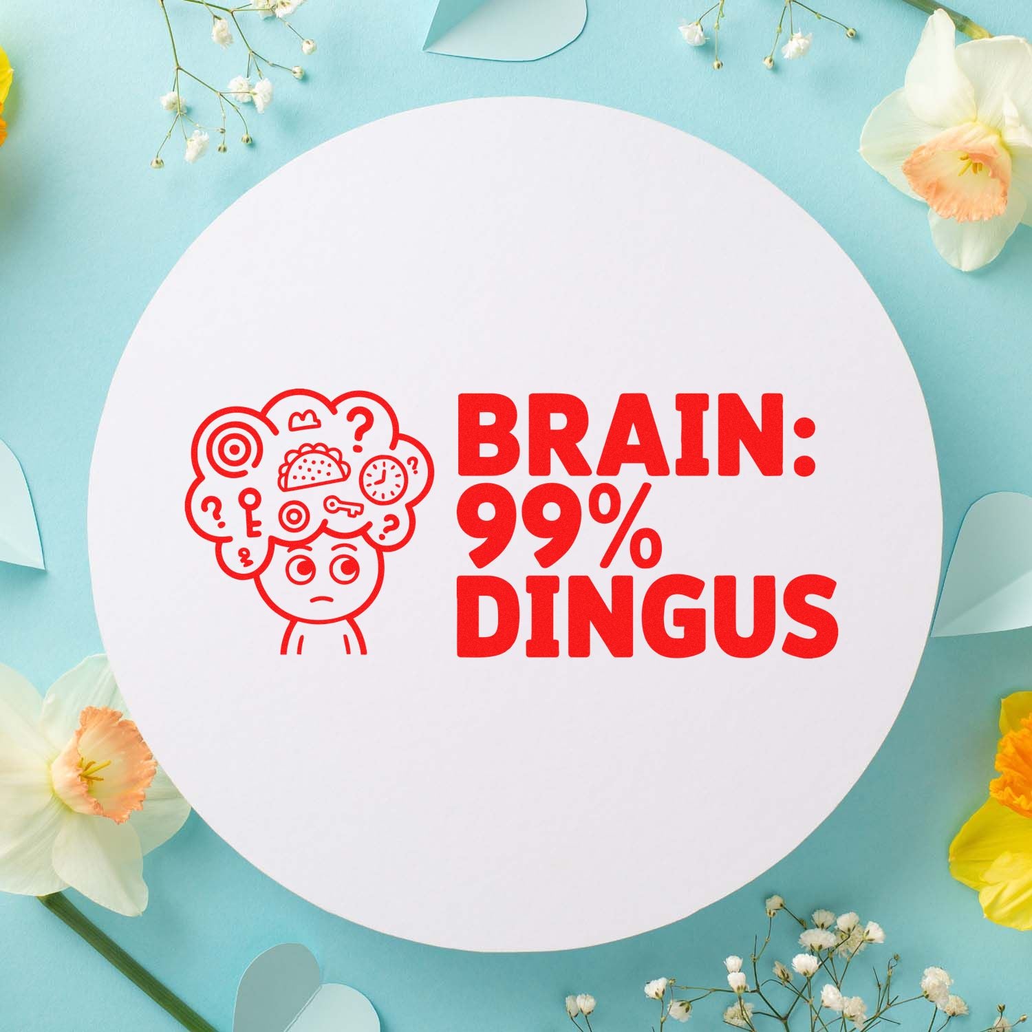 Red brain 99% dingus stamp on white round seal, on pastel blue background with spring flowers.