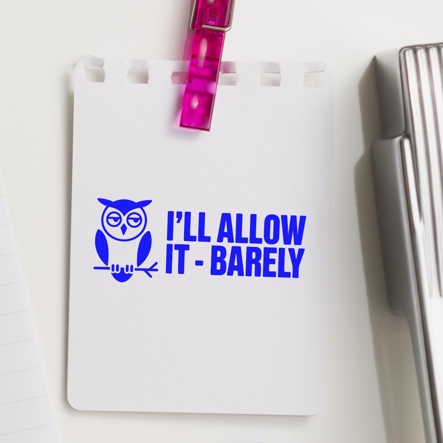Blue owl stamp and seal reading ILL ALLOW IT - BARELY on white card, clipped with a translucent pink clip.