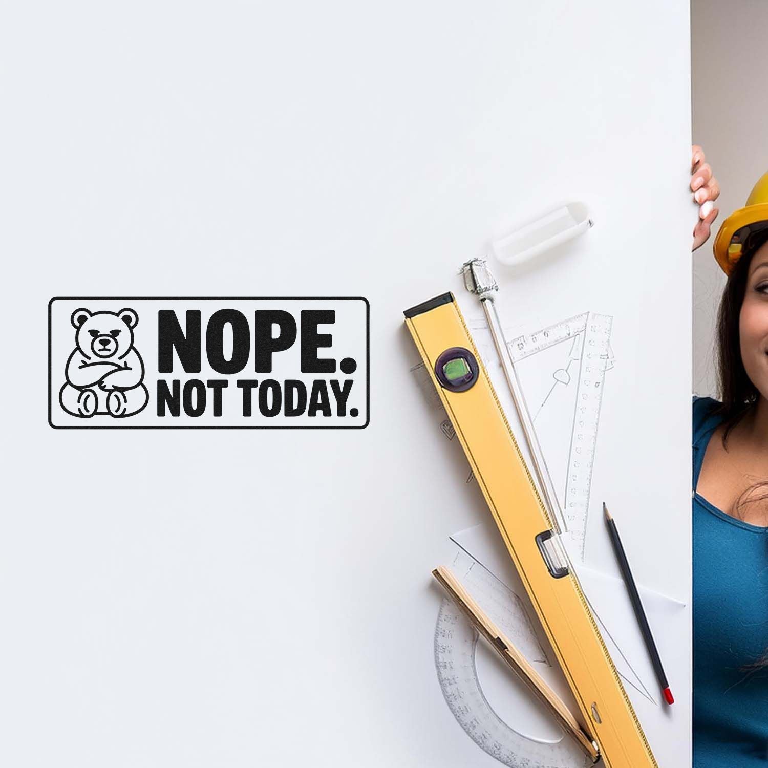 Black bear rubber stamp reading NOPE. NOT TODAY. on white board with yellow level, rulers, and hard-hat worker.