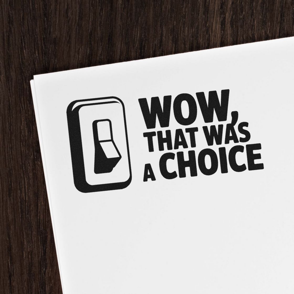 Black stamp seal on white paper with bold text, WOW, THAT WAS A CHOICE, and a simple black icon.