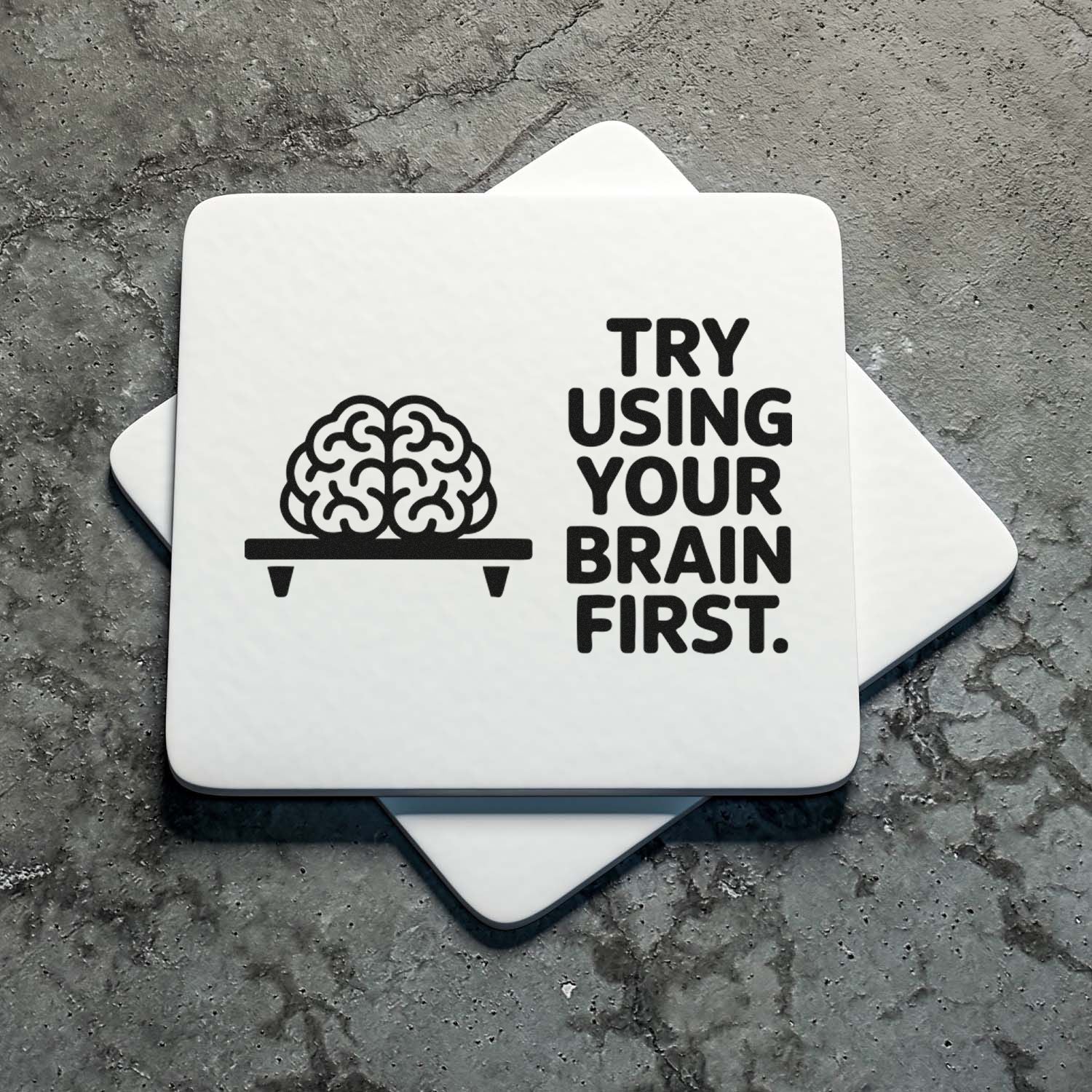 White stamp and seal with black brain icon and TRY USING YOUR BRAIN FIRST on gray textured background.