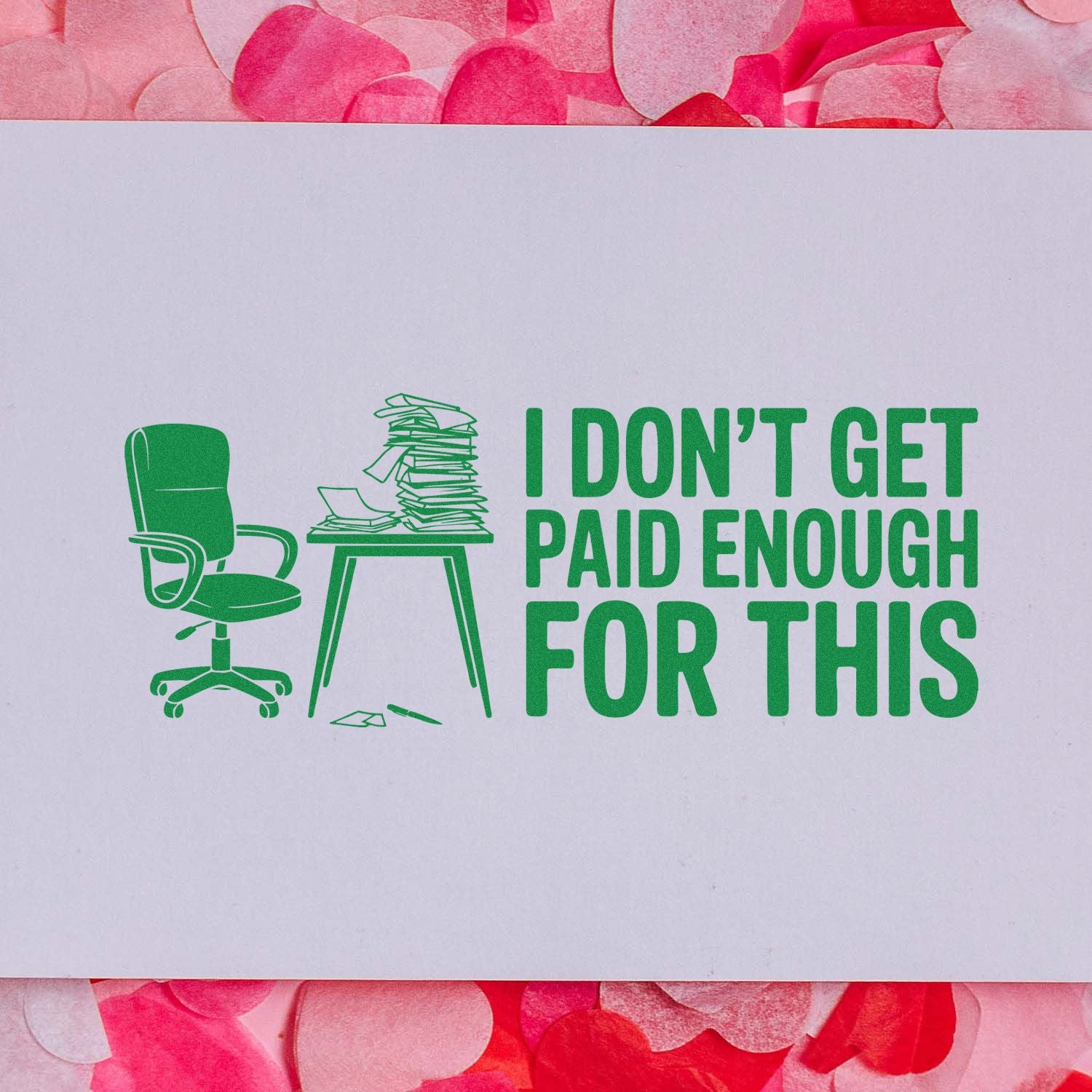 Green office stamp seal with chair, piled desk and I DONT GET PAID ENOUGH FOR THIS on white paper over pink confetti background