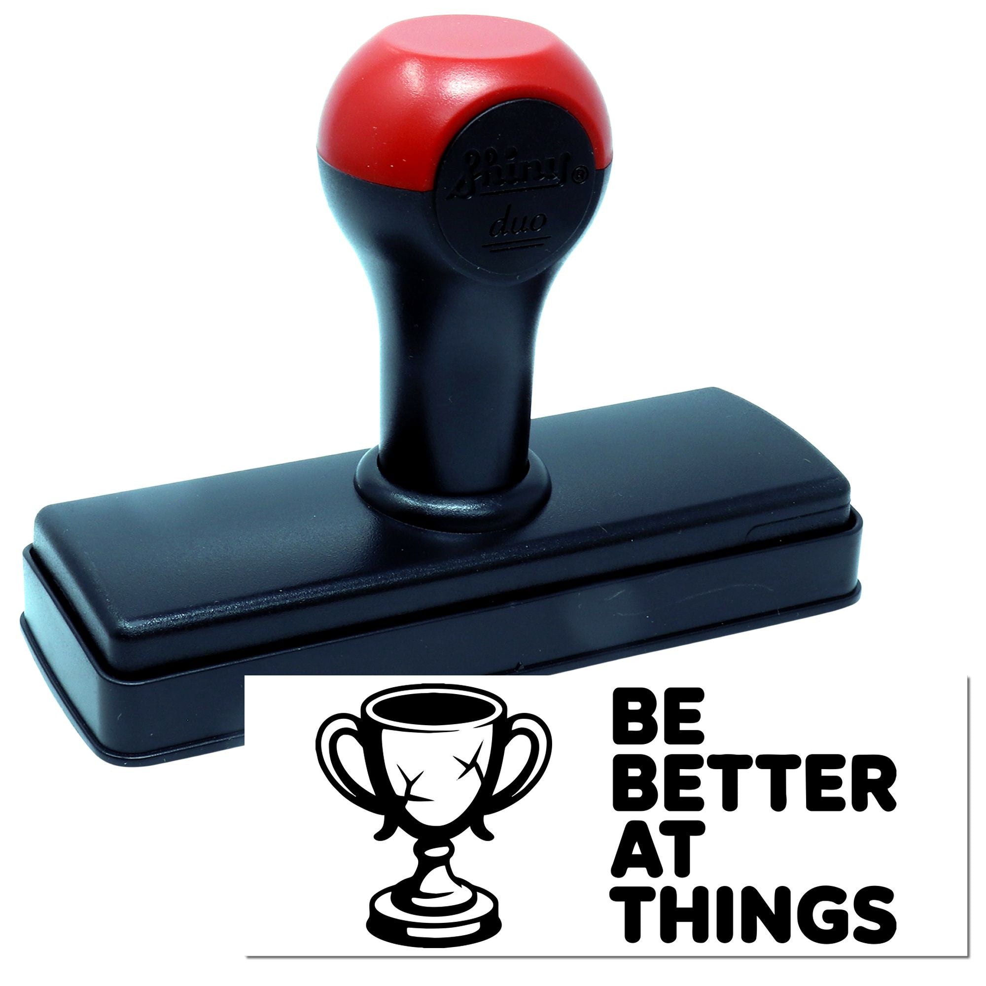 Red and black self-inking stamp with trophy seal and Be Better at Things design on white background.