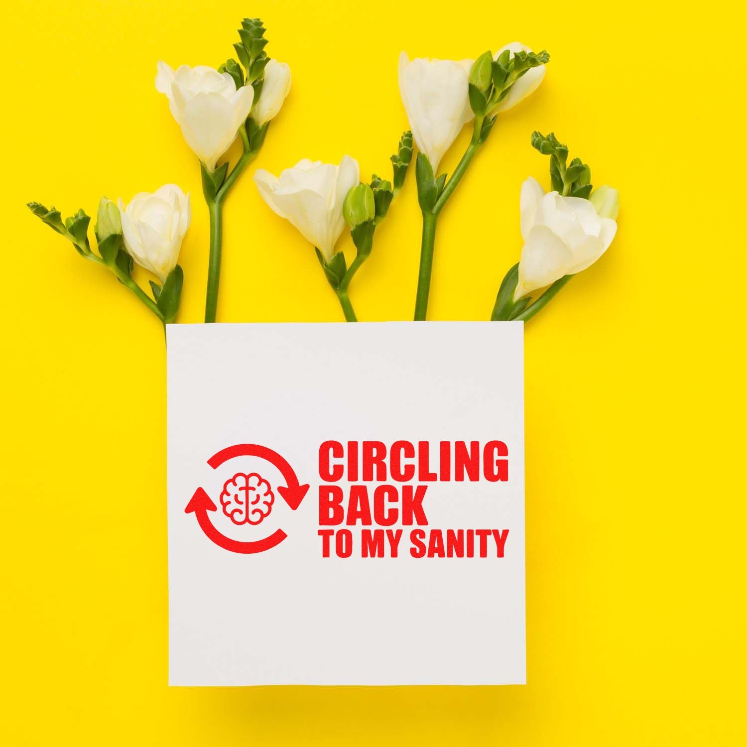 White flowers around a white card with a red circular stamp seal and brain icon reading Circling Back to My Sanity on yellow.