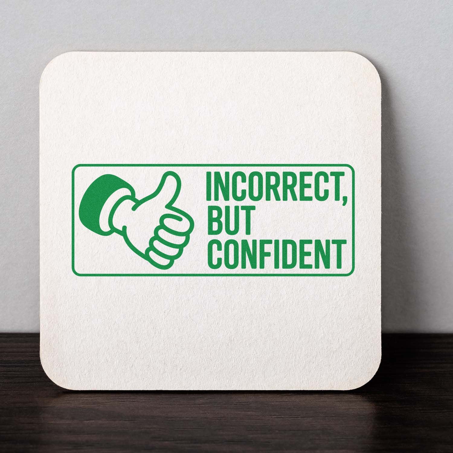 Green stamp and seal product with thumbs-up icon and Incorrect, but confident text on a white square coaster.