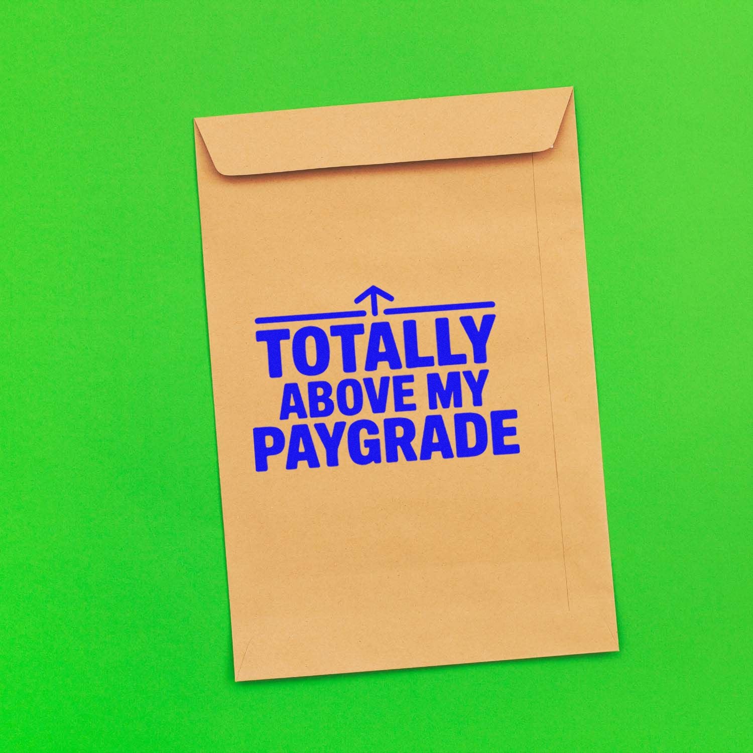 Blue stamp seal reading Totally Above My Paygrade on a tan kraft envelope against a bright green background.