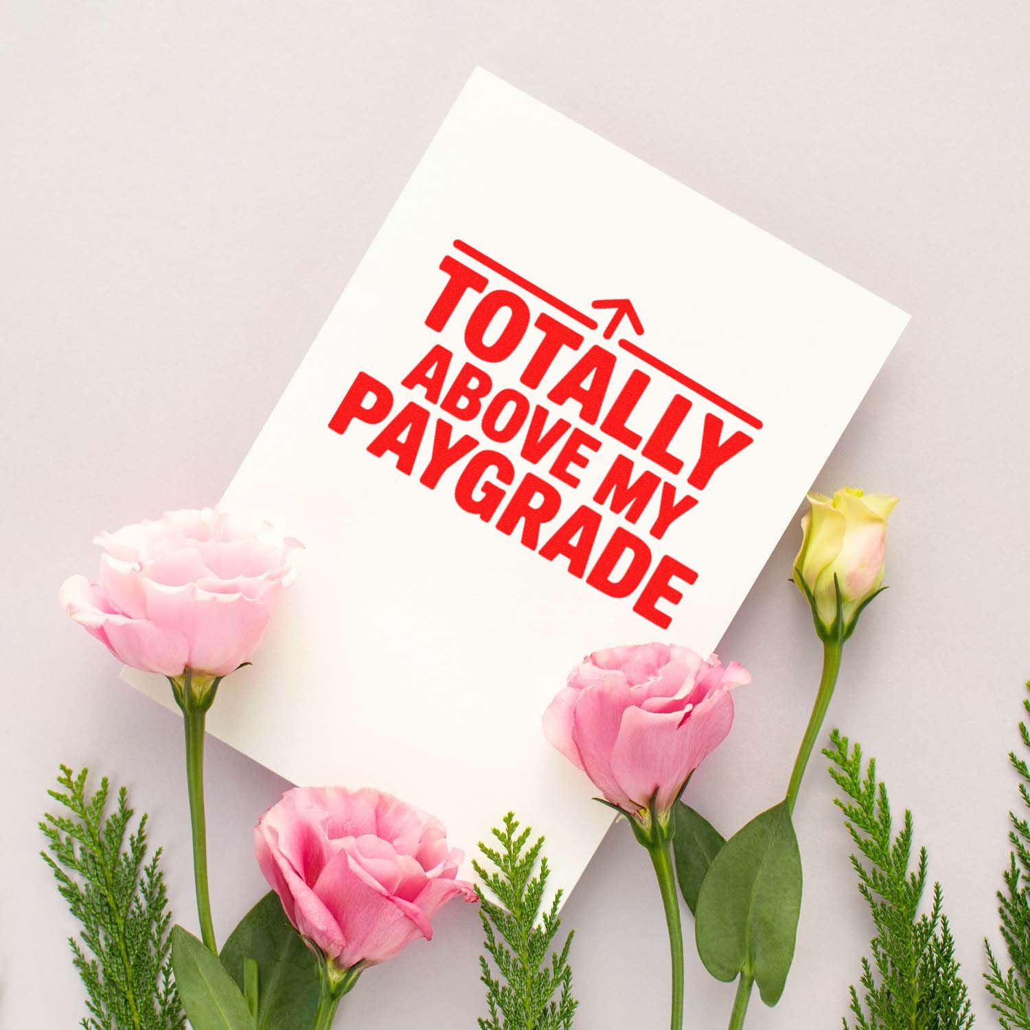 White stamp and seal card with red Totally Above My Pay Grade text, framed by pink flowers and green stems.