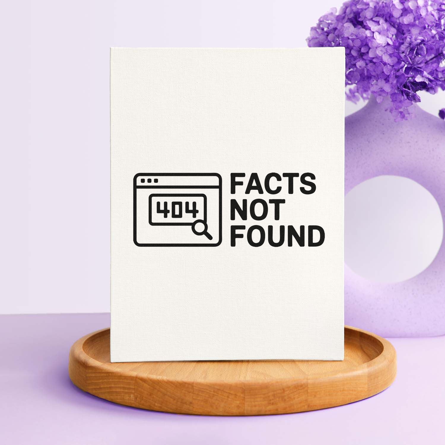 White stamp and seal card with black 404 Facts Not Found design, on a wooden base with purple decor.