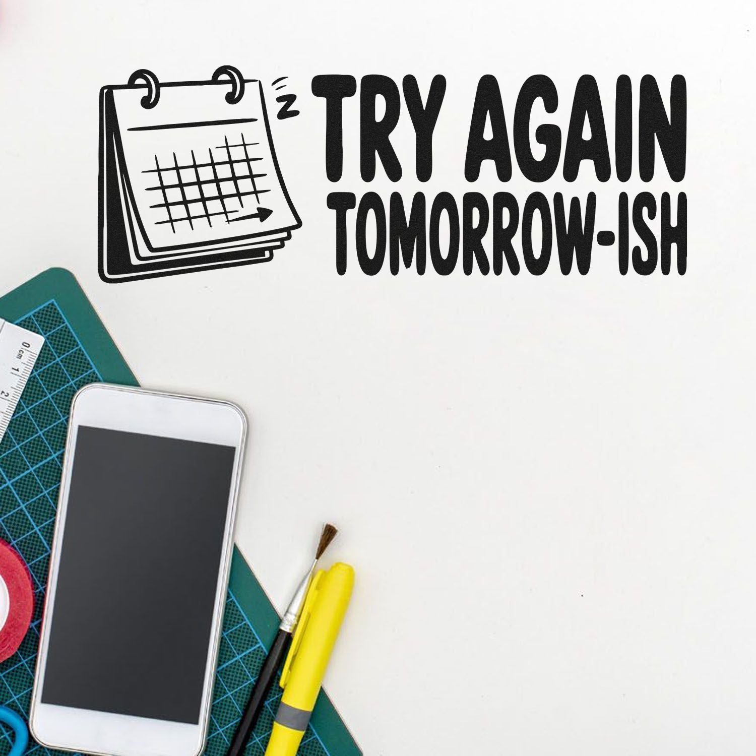 Black rubber stamp design with Try Again Tomorrow-ish text, calendar icon, and craft tools on a white background.