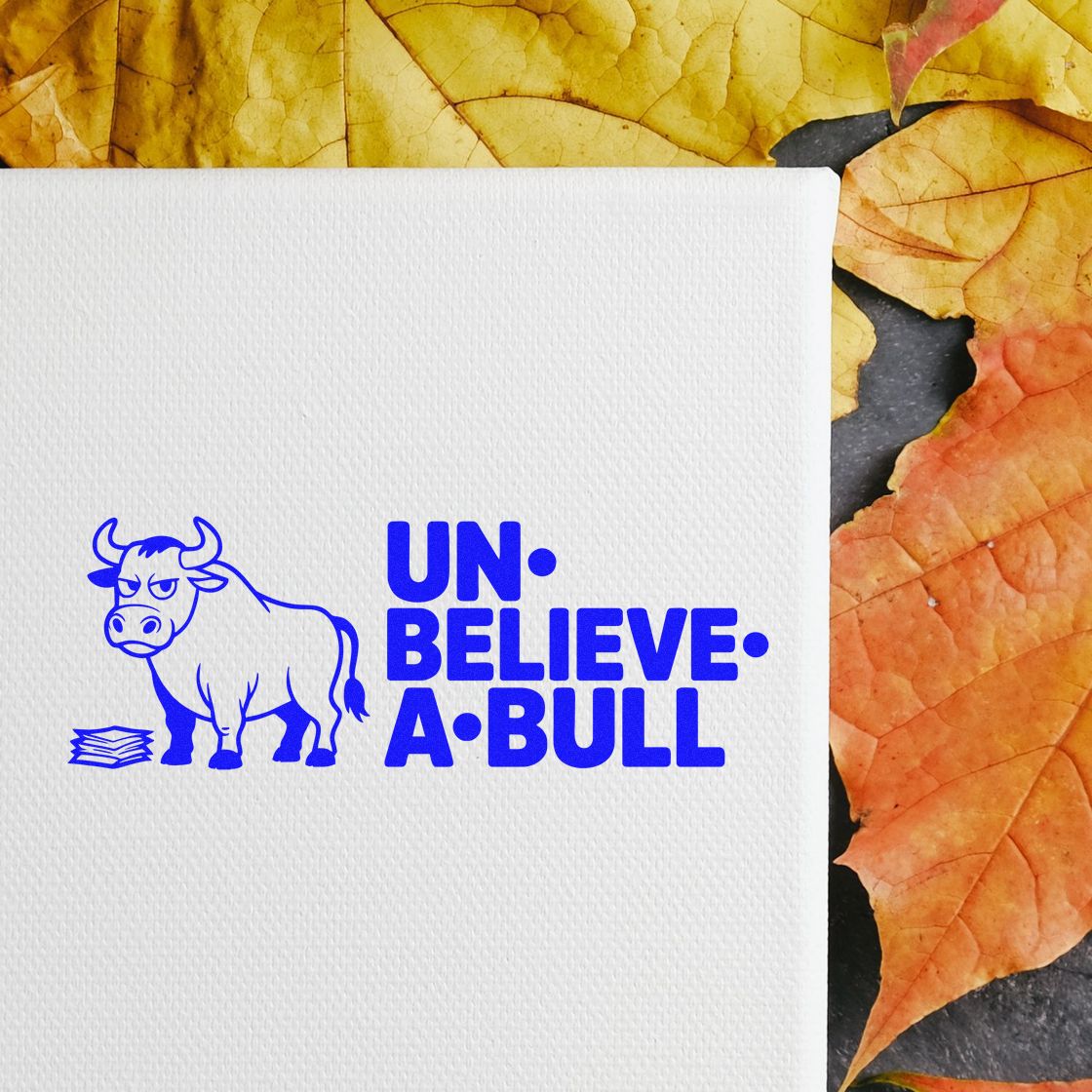 Blue bull stamp seal with UN-BELIEVE-A-BULL text on white textured paper, set against yellow and orange autumn leaves.